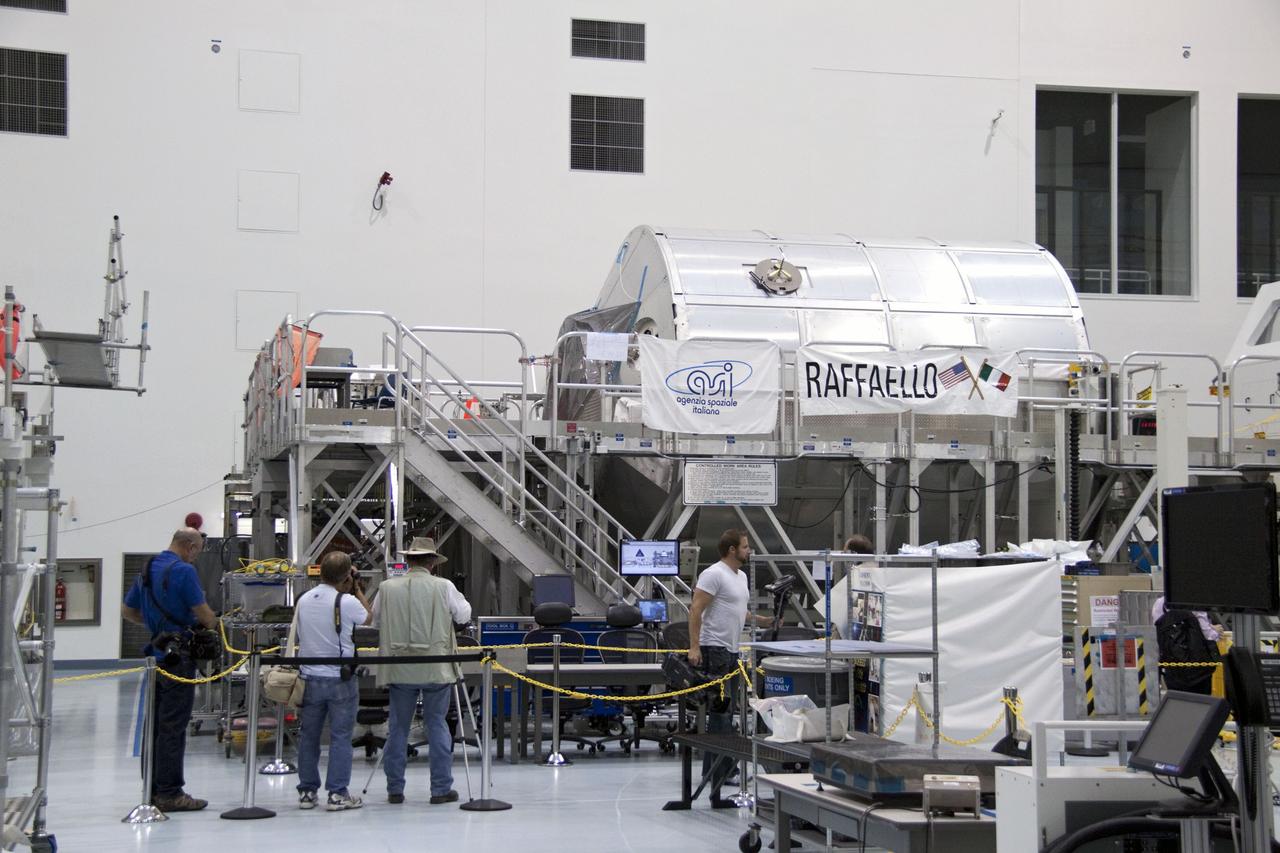 CAPE CANAVERAL, Fla. -- In the Space Station Processing Facility at NASA's Kennedy Space Center in Florida, media snap photos of the payload for shuttle Atlantis' flight to the International Space Station. Commander Chris Ferguson, Pilot Doug Hurley and Mission Specialists Sandra Magnus and Rex Walheim are targeted to lift off on July 8, taking with them the Raffaello multi-purpose logistics module packed with supplies, logistics and spare parts. The STS-135 mission also will fly a system to investigate the potential for robotically refueling existing spacecraft and return a failed ammonia pump module to help NASA better understand the failure mechanism and improve pump designs for future systems. STS-135 will be the 33rd flight of Atlantis, the 37th shuttle mission to the space station, and the 135th and final mission of NASA's Space Shuttle Program. For more information visit, www.nasa.gov/mission_pages/shuttle/shuttlemissions/sts135/index.html. Photo credit: NASA/Jack Pfaller