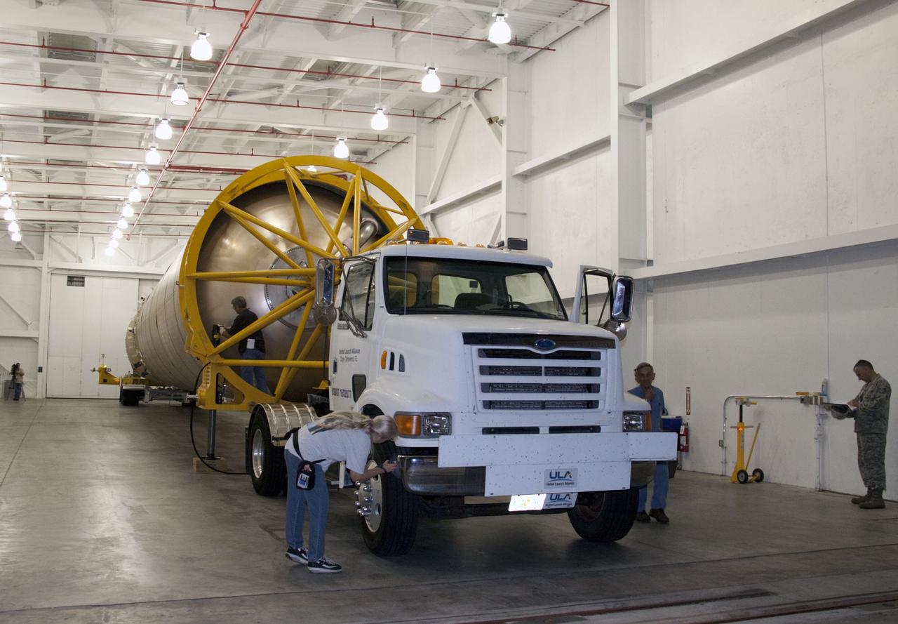 CAPE CANAVERAL, Fla. -- At Cape Canaveral Air Force Station in Florida, workers prepare the first stage of a United Launch Alliance Atlas V rocket for transport from its hangar at the Atlas Spaceflight Operations Center to Launch Complex 41.                NASA's Juno spacecraft is scheduled to launch aboard an Atlas V from Cape Canaveral, Fla. Aug. 5.The solar-powered spacecraft will orbit Jupiter's poles 33 times to find out more about the gas giant's origins, structure, atmosphere and magnetosphere and investigate the existence of a solid planetary core. For more information visit: www.nasa.gov/juno. Photo credit: NASA/Jack Pfaller