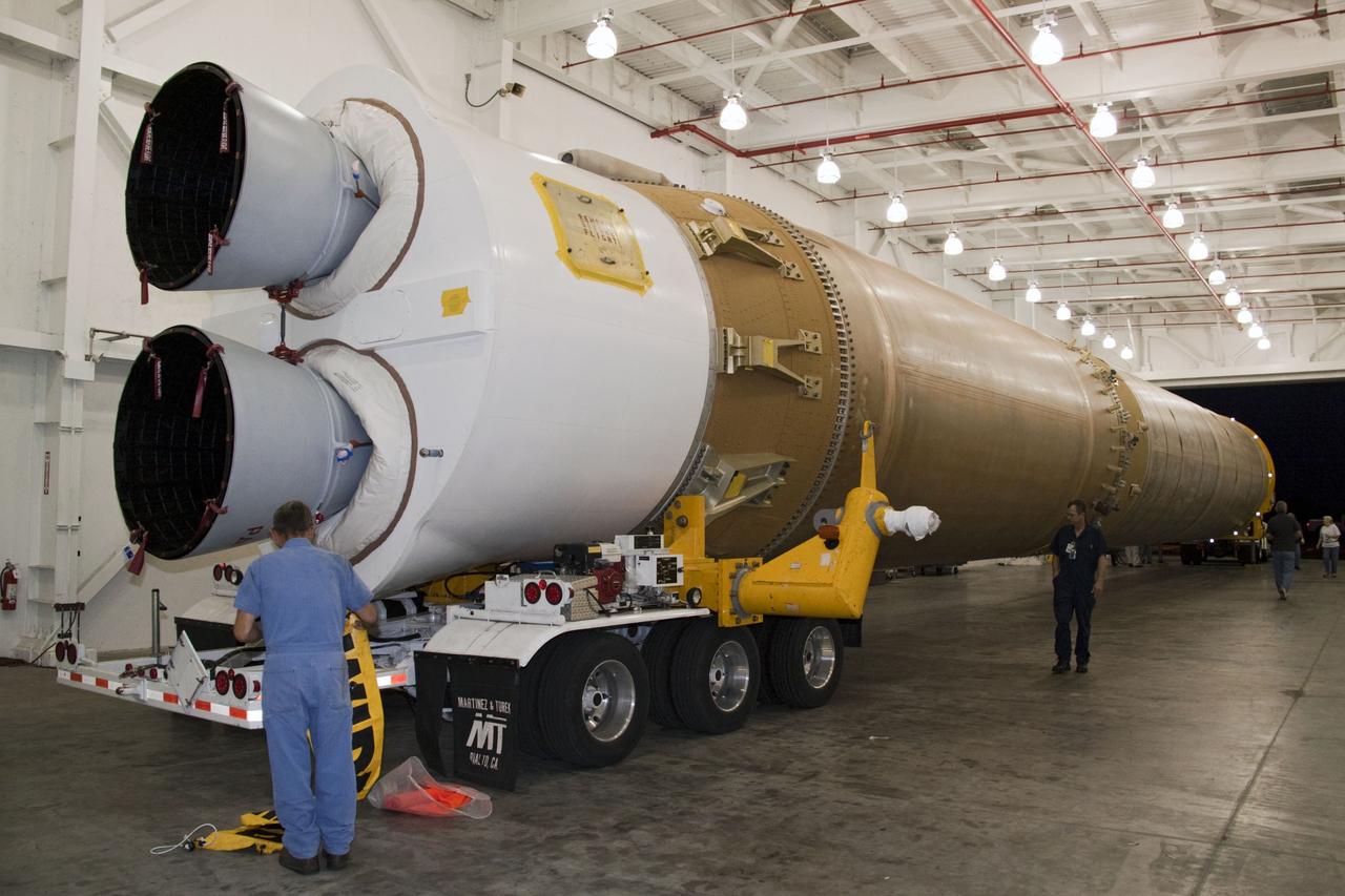 CAPE CANAVERAL, Fla. -- At Cape Canaveral Air Force Station in Florida, workers prepare the first stage of a United Launch Alliance Atlas V rocket for transport from its hangar at the Atlas Spaceflight Operations Center to Launch Complex 41.                NASA's Juno spacecraft is scheduled to launch aboard an Atlas V from Cape Canaveral, Fla. Aug. 5.The solar-powered spacecraft will orbit Jupiter's poles 33 times to find out more about the gas giant's origins, structure, atmosphere and magnetosphere and investigate the existence of a solid planetary core. For more information visit: www.nasa.gov/juno. Photo credit: NASA/Jack Pfaller