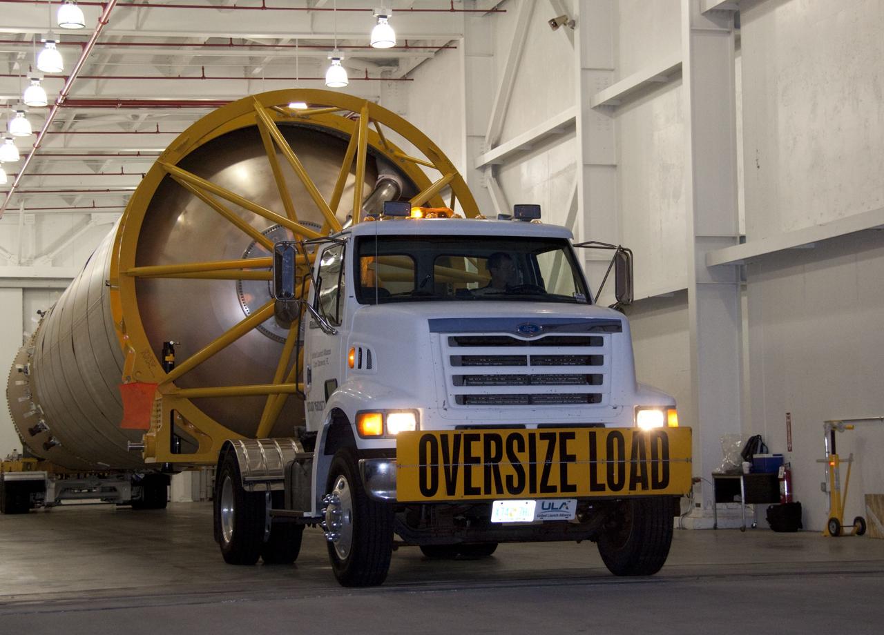 CAPE CANAVERAL, Fla. -- At Cape Canaveral Air Force Station in Florida, workers prepare the first stage of a United Launch Alliance Atlas V rocket for transport from its hangar at the Atlas Spaceflight Operations Center to Launch Complex 41. NASA's Juno spacecraft is scheduled to launch aboard an Atlas V from Cape Canaveral, Fla. Aug. 5.The solar-powered spacecraft will orbit Jupiter's poles 33 times to find out more about the gas giant's origins, structure, atmosphere and magnetosphere and investigate the existence of a solid planetary core. For more information visit: www.nasa.gov/juno. Photo credit: NASA/Jack Pfaller