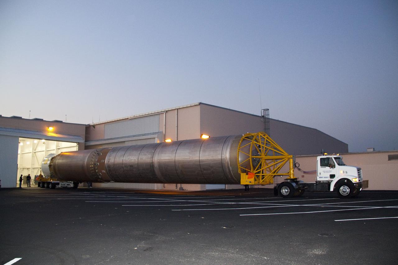 CAPE CANAVERAL, Fla. -- At Cape Canaveral Air Force Station in Florida, the first stage of a United Launch Alliance Atlas V rocket is being transported from its hangar at the Atlas Spaceflight Operations Center to Launch Complex 41. NASA's Juno spacecraft is scheduled to launch aboard an Atlas V from Cape Canaveral, Fla. Aug. 5.The solar-powered spacecraft will orbit Jupiter's poles 33 times to find out more about the gas giant's origins, structure, atmosphere and magnetosphere and investigate the existence of a solid planetary core. For more information visit: www.nasa.gov/juno. Photo credit: NASA/Jack Pfaller