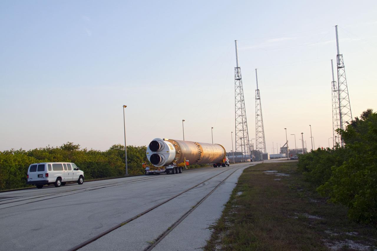 CAPE CANAVERAL, Fla. -- At Cape Canaveral Air Force Station in Florida, the first stage of a United Launch Alliance Atlas V rocket is being transported from its hangar at the Atlas Spaceflight Operations Center to Launch Complex 41. NASA's Juno spacecraft is scheduled to launch aboard an Atlas V from Cape Canaveral, Fla. Aug. 5.The solar-powered spacecraft will orbit Jupiter's poles 33 times to find out more about the gas giant's origins, structure, atmosphere and magnetosphere and investigate the existence of a solid planetary core. For more information visit: www.nasa.gov/juno. Photo credit: NASA/Jack Pfaller