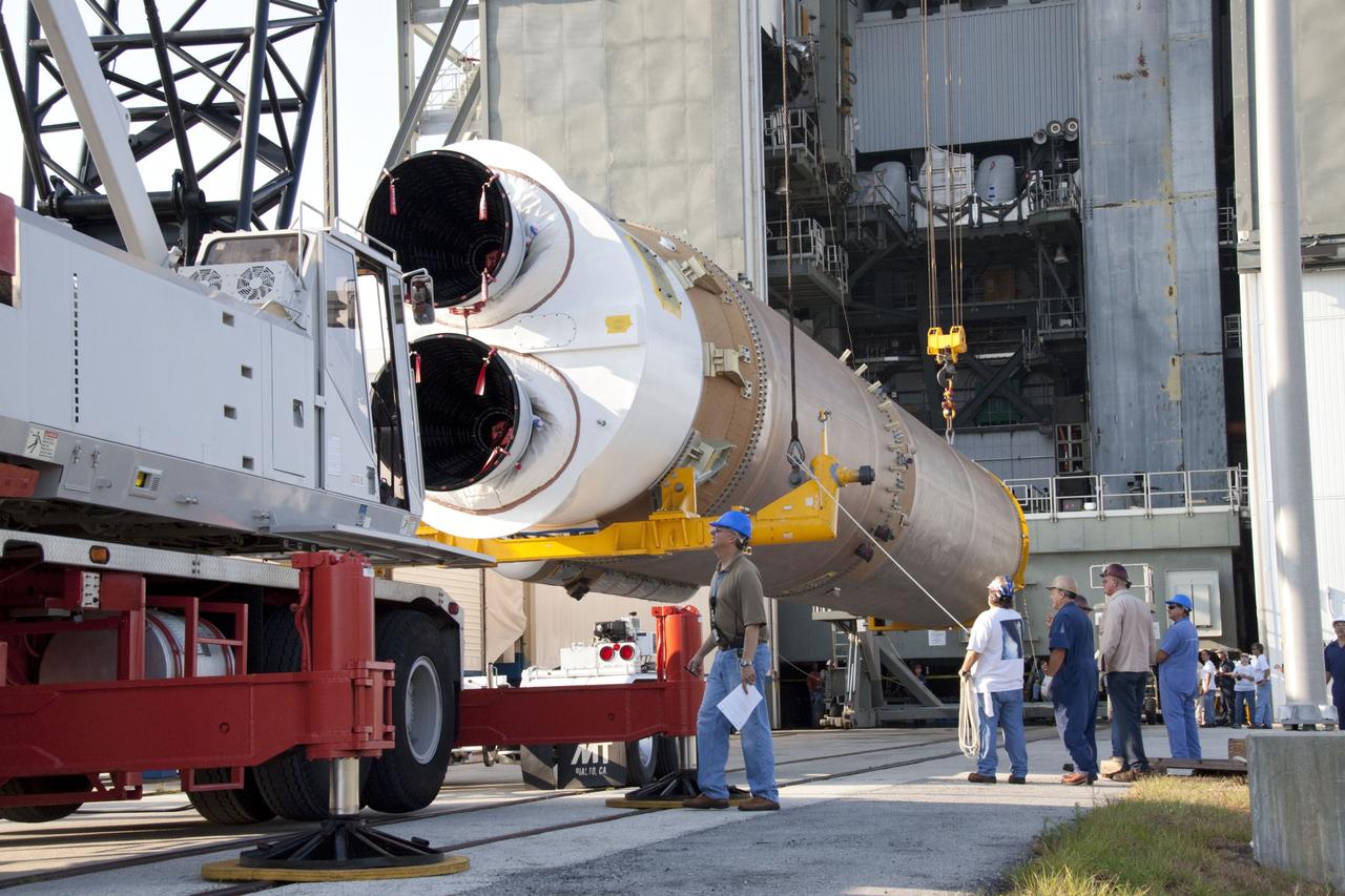 CAPE CANAVERAL, Fla. -- At Cape Canaveral Air Force Station in Florida, workers use an overhead crane to lift the first stage of a United Launch Alliance Atlas V rocket into the Vertical Integration Facility at Launch Complex 41. NASA's Juno spacecraft is scheduled to launch aboard an Atlas V from Cape Canaveral, Fla. Aug. 5.The solar-powered spacecraft will orbit Jupiter's poles 33 times to find out more about the gas giant's origins, structure, atmosphere and magnetosphere and investigate the existence of a solid planetary core. For more information visit: www.nasa.gov/juno. Photo credit: NASA/Jack Pfaller