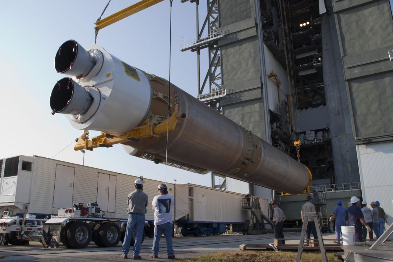 CAPE CANAVERAL, Fla. -- At Cape Canaveral Air Force Station in Florida, workers use an overhead crane to lift the first stage of a United Launch Alliance Atlas V rocket into the Vertical Integration Facility at Launch Complex 41. NASA's Juno spacecraft is scheduled to launch aboard an Atlas V from Cape Canaveral, Fla. Aug. 5.The solar-powered spacecraft will orbit Jupiter's poles 33 times to find out more about the gas giant's origins, structure, atmosphere and magnetosphere and investigate the existence of a solid planetary core. For more information visit: www.nasa.gov/juno. Photo credit: NASA/Jack Pfaller
