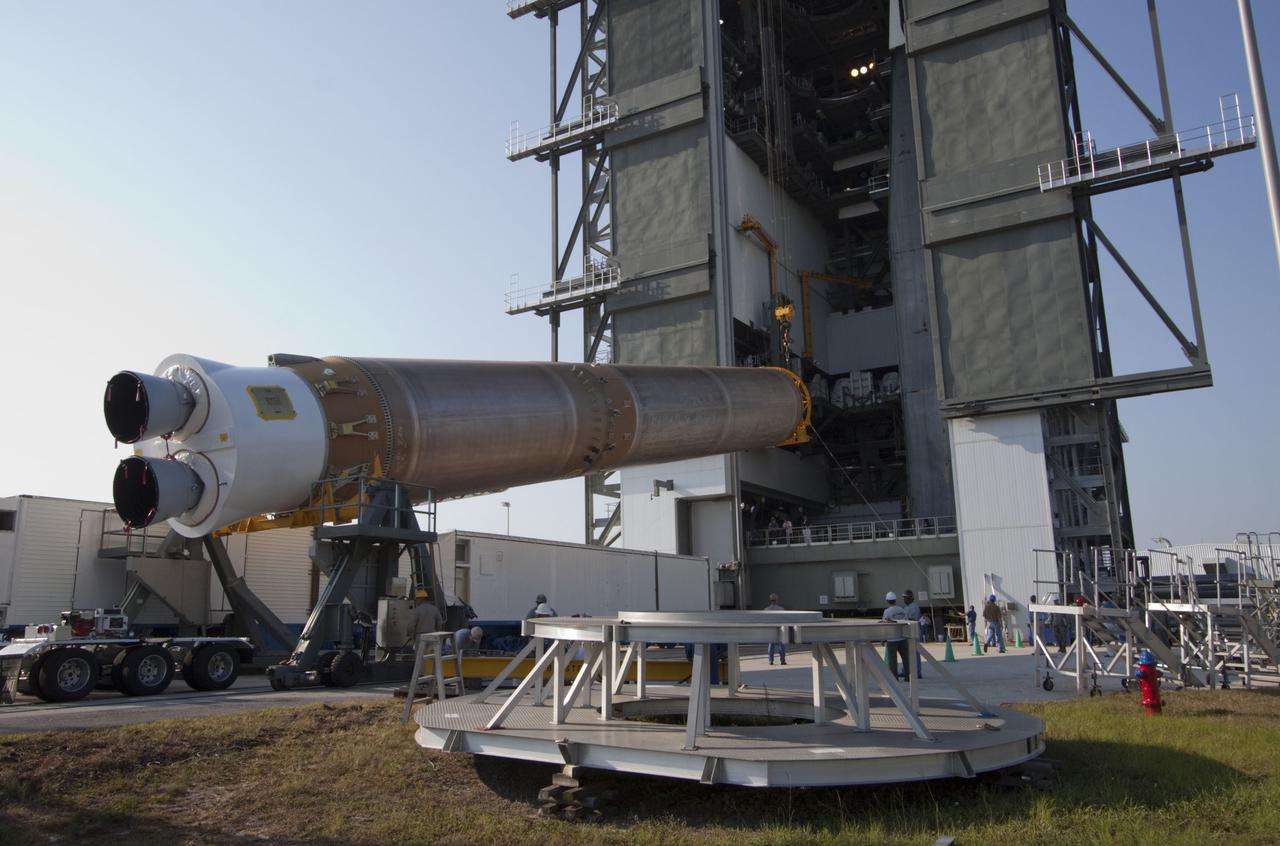 CAPE CANAVERAL, Fla. -- At Cape Canaveral Air Force Station in Florida, workers use an overhead crane to lift the first stage of a United Launch Alliance Atlas V rocket into the Vertical Integration Facility at Launch Complex 41. NASA's Juno spacecraft is scheduled to launch aboard an Atlas V from Cape Canaveral, Fla. Aug. 5.The solar-powered spacecraft will orbit Jupiter's poles 33 times to find out more about the gas giant's origins, structure, atmosphere and magnetosphere and investigate the existence of a solid planetary core. For more information visit: www.nasa.gov/juno. Photo credit: NASA/Jack Pfaller