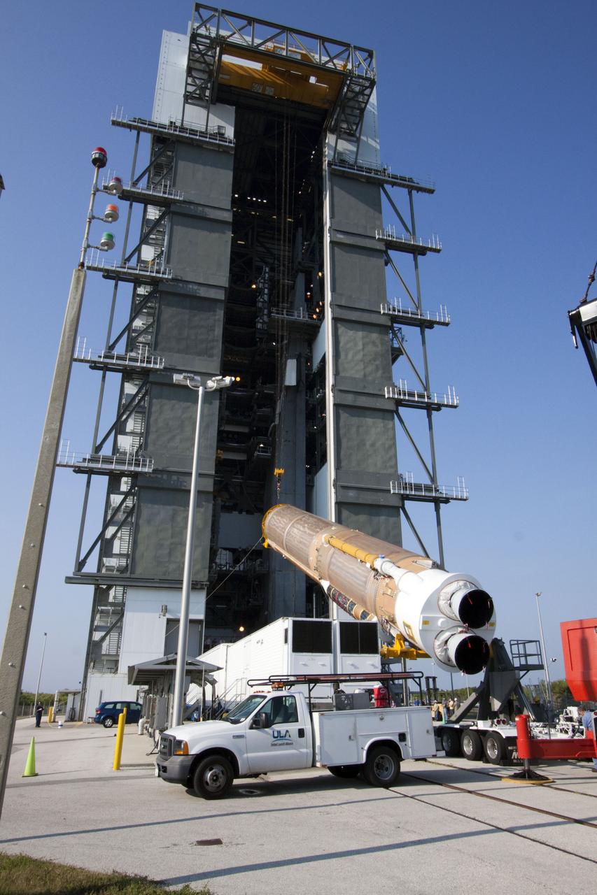 CAPE CANAVERAL, Fla. -- At Cape Canaveral Air Force Station in Florida, workers use an overhead crane to lift the first stage of a United Launch Alliance Atlas V rocket into the Vertical Integration Facility at Launch Complex 41. NASA's Juno spacecraft is scheduled to launch aboard an Atlas V from Cape Canaveral, Fla. Aug. 5.The solar-powered spacecraft will orbit Jupiter's poles 33 times to find out more about the gas giant's origins, structure, atmosphere and magnetosphere and investigate the existence of a solid planetary core. For more information visit: www.nasa.gov/juno. Photo credit: NASA/Jack Pfaller