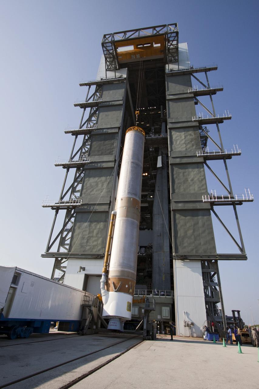 CAPE CANAVERAL, Fla. -- At Cape Canaveral Air Force Station in Florida, workers use an overhead crane to lift the first stage of a United Launch Alliance Atlas V rocket into the Vertical Integration Facility at Launch Complex 41. NASA's Juno spacecraft is scheduled to launch aboard an Atlas V from Cape Canaveral, Fla. Aug. 5.The solar-powered spacecraft will orbit Jupiter's poles 33 times to find out more about the gas giant's origins, structure, atmosphere and magnetosphere and investigate the existence of a solid planetary core. For more information visit: www.nasa.gov/juno. Photo credit: NASA/Jack Pfaller
