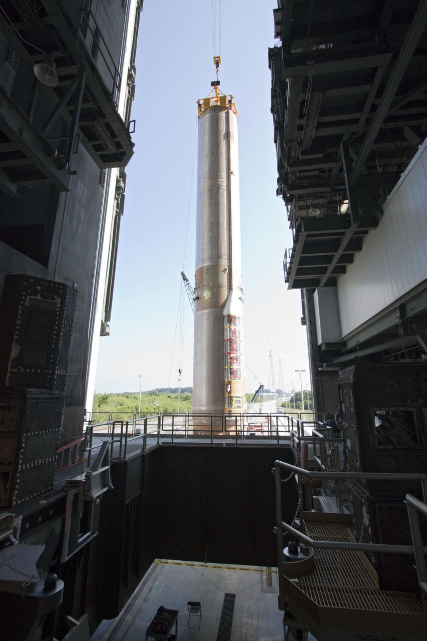 CAPE CANAVERAL, Fla. -- At Cape Canaveral Air Force Station in Florida, workers use an overhead crane to lift the first stage of a United Launch Alliance Atlas V rocket into the Vertical Integration Facility at Launch Complex 41. NASA's Juno spacecraft is scheduled to launch aboard an Atlas V from Cape Canaveral, Fla. Aug. 5.The solar-powered spacecraft will orbit Jupiter's poles 33 times to find out more about the gas giant's origins, structure, atmosphere and magnetosphere and investigate the existence of a solid planetary core. For more information visit: www.nasa.gov/juno. Photo credit: NASA/Jack Pfaller