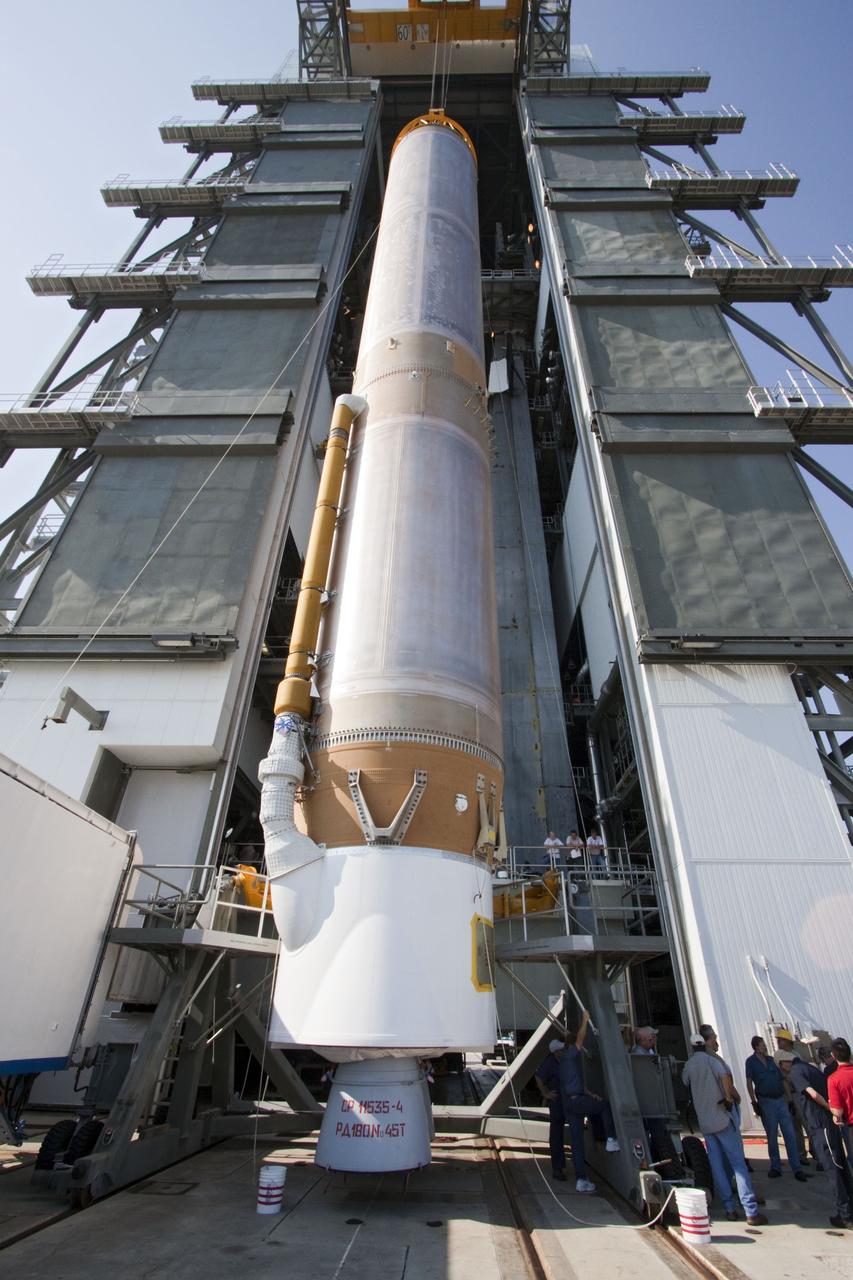 CAPE CANAVERAL, Fla. -- At Cape Canaveral Air Force Station in Florida, workers use an overhead crane to lift the first stage of a United Launch Alliance Atlas V rocket into the Vertical Integration Facility at Launch Complex 41. NASA's Juno spacecraft is scheduled to launch aboard an Atlas V from Cape Canaveral, Fla. Aug. 5.The solar-powered spacecraft will orbit Jupiter's poles 33 times to find out more about the gas giant's origins, structure, atmosphere and magnetosphere and investigate the existence of a solid planetary core. For more information visit: www.nasa.gov/juno. Photo credit: NASA/Jack Pfaller