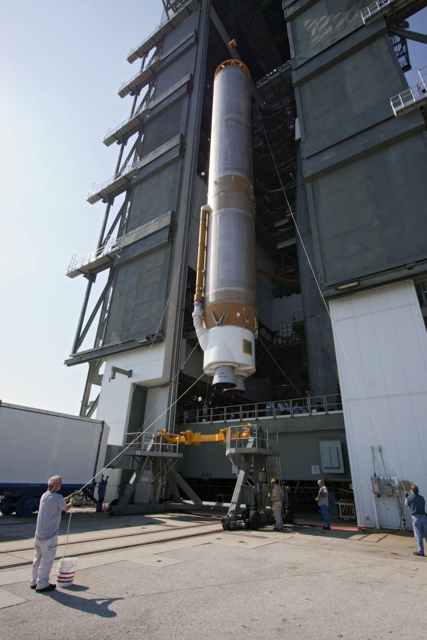 CAPE CANAVERAL, Fla. -- At Cape Canaveral Air Force Station in Florida, workers use an overhead crane to lift the first stage of a United Launch Alliance Atlas V rocket into the Vertical Integration Facility at Launch Complex 41.          NASA's Juno spacecraft is scheduled to launch aboard an Atlas V from Cape Canaveral, Fla. Aug. 5.The solar-powered spacecraft will orbit Jupiter's poles 33 times to find out more about the gas giant's origins, structure, atmosphere and magnetosphere and investigate the existence of a solid planetary core. For more information visit: www.nasa.gov/juno. Photo credit: NASA/Jack Pfaller