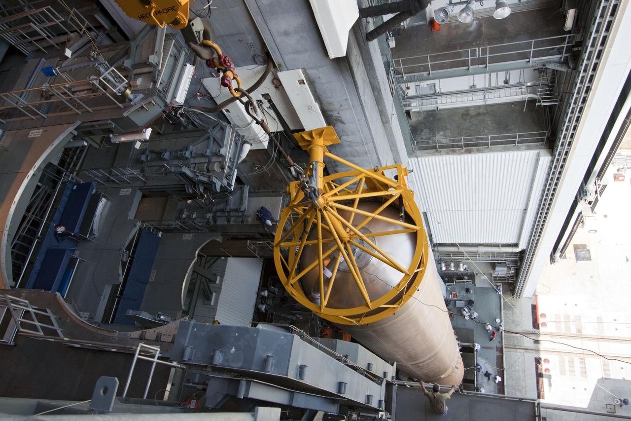 CAPE CANAVERAL, Fla. -- At Cape Canaveral Air Force Station in Florida, workers use an overhead crane to lift the first stage of a United Launch Alliance Atlas V rocket into the Vertical Integration Facility at Launch Complex 41. NASA's Juno spacecraft is scheduled to launch aboard an Atlas V from Cape Canaveral, Fla. Aug. 5.The solar-powered spacecraft will orbit Jupiter's poles 33 times to find out more about the gas giant's origins, structure, atmosphere and magnetosphere and investigate the existence of a solid planetary core. For more information visit: www.nasa.gov/juno. Photo credit: NASA/Jack Pfaller