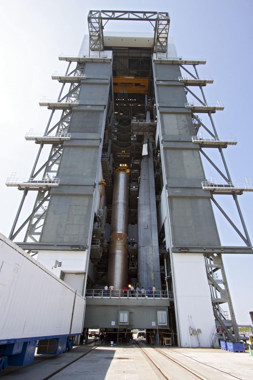 CAPE CANAVERAL, Fla. -- At Cape Canaveral Air Force Station in Florida, workers use an overhead crane to lift the first stage of a United Launch Alliance Atlas V rocket into the Vertical Integration Facility at Launch Complex 41. NASA's Juno spacecraft is scheduled to launch aboard an Atlas V from Cape Canaveral, Fla. Aug. 5.The solar-powered spacecraft will orbit Jupiter's poles 33 times to find out more about the gas giant's origins, structure, atmosphere and magnetosphere and investigate the existence of a solid planetary core. For more information visit: www.nasa.gov/juno. Photo credit: NASA/Jack Pfaller