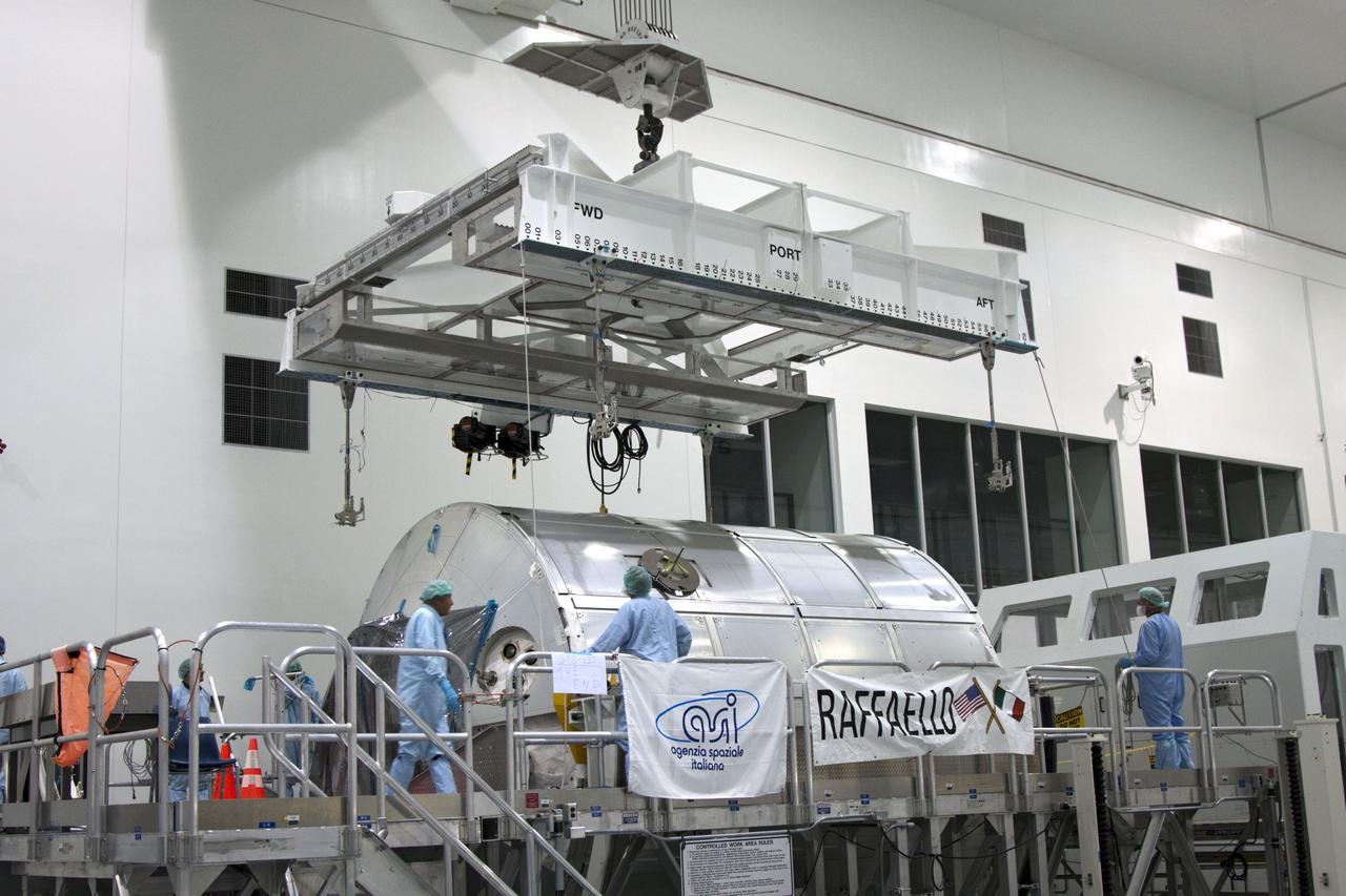 CAPE CANAVERAL, Fla. -- In the Space Station Processing Facility at NASA's Kennedy Space Center in Florida, technicians lower an overhead crane toward the Raffaello multi-purpose logistics module, or MPLM, for its move toward a payload canister.    Commander Chris Ferguson, Pilot Doug Hurley and Mission Specialists Sandra Magnus and Rex Walheim are targeted to lift off on space shuttle Atlantis July 8, taking with them the MPLM packed with supplies, logistics and spare parts to the International Space Station. The STS-135 mission also will fly a system to investigate the potential for robotically refueling existing spacecraft and return a failed ammonia pump module to help NASA better understand the failure mechanism and improve pump designs for future systems. STS-135 will be the 33rd flight of Atlantis, the 37th shuttle mission to the space station, and the 135th and final mission of NASA's Space Shuttle Program. For more information, visit www.nasa.gov/mission_pages/shuttle/shuttlemissions/sts135/index.html. Photo credit: NASA/Jim Grossmann