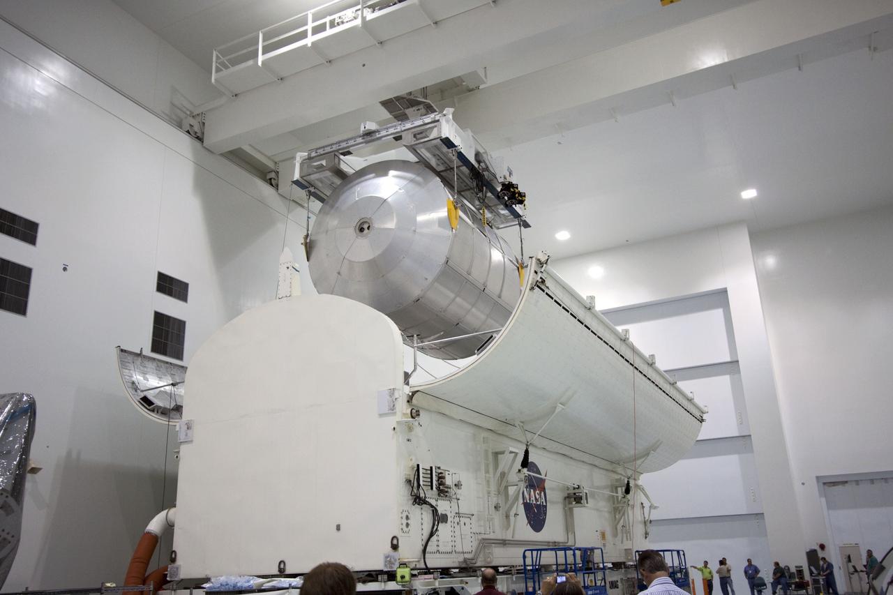 CAPE CANAVERAL, Fla. -- In the Space Station Processing Facility at NASA's Kennedy Space Center in Florida, an overhead crane lowers the Raffaello multi-purpose logistics module, or MPLM, into a payload canister.    Commander Chris Ferguson, Pilot Doug Hurley and Mission Specialists Sandra Magnus and Rex Walheim are targeted to lift off on space shuttle Atlantis July 8, taking with them the MPLM packed with supplies, logistics and spare parts to the International Space Station. The STS-135 mission also will fly a system to investigate the potential for robotically refueling existing spacecraft and return a failed ammonia pump module to help NASA better understand the failure mechanism and improve pump designs for future systems. STS-135 will be the 33rd flight of Atlantis, the 37th shuttle mission to the space station, and the 135th and final mission of NASA's Space Shuttle Program. For more information, visit www.nasa.gov/mission_pages/shuttle/shuttlemissions/sts135/index.html. Photo credit: NASA/Jim Grossmann
