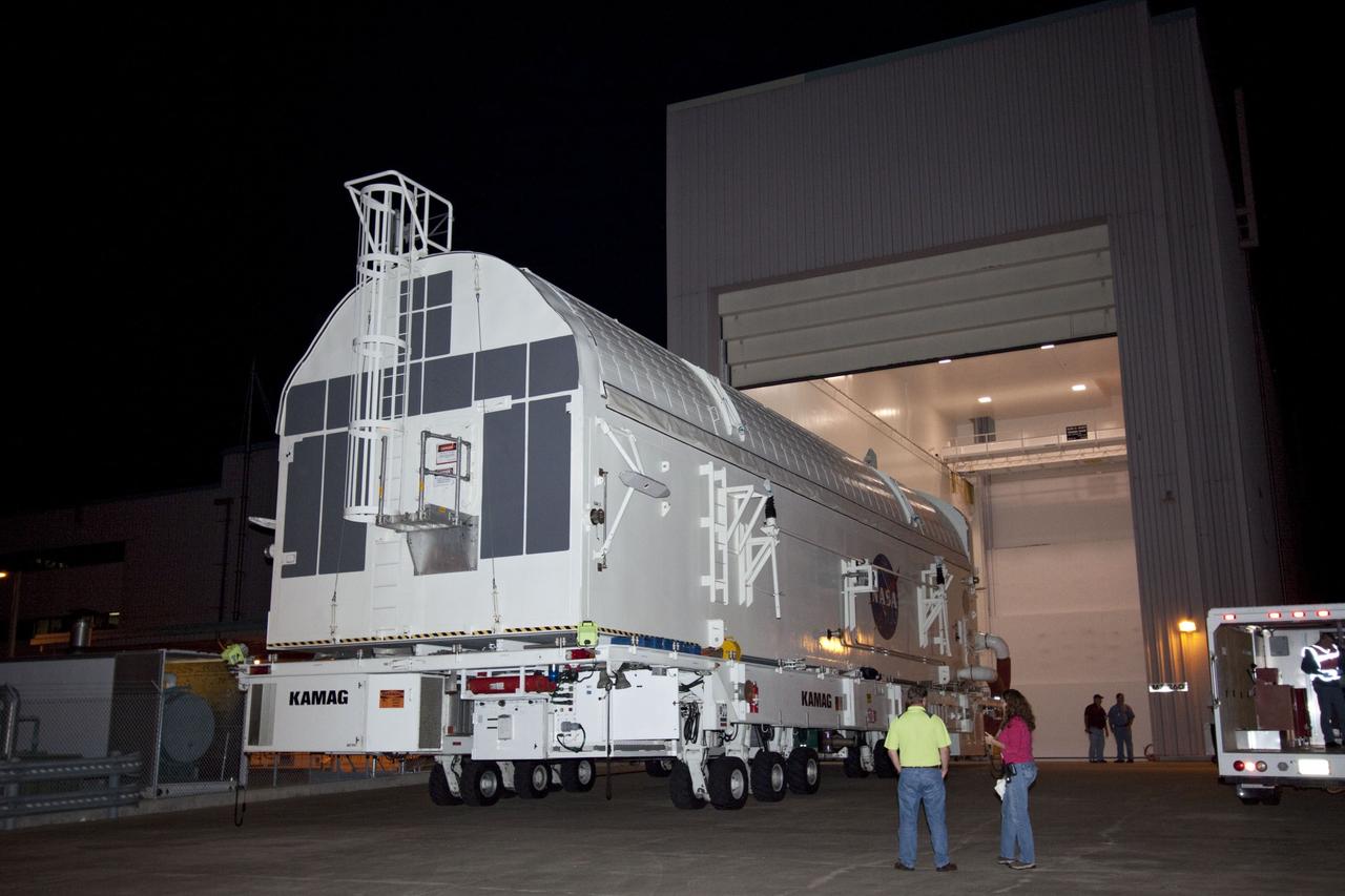 CAPE CANAVERAL, Fla. -- Workers move the payload canister, atop its transporter with the Raffaello multi-purpose logistics module, or MPLM, secured inside, from the Space Station Processing Facility at NASA's Kennedy Space Center in Florida to the Canister Rotation Facility. Commander Chris Ferguson, Pilot Doug Hurley and Mission Specialists Sandra Magnus and Rex Walheim are targeted to lift off on space shuttle Atlantis July 8, taking with them the MPLM packed with supplies, logistics and spare parts to the International Space Station. The STS-135 mission also will fly a system to investigate the potential for robotically refueling existing spacecraft and return a failed ammonia pump module to help NASA better understand the failure mechanism and improve pump designs for future systems. STS-135 will be the 33rd flight of Atlantis, the 37th shuttle mission to the space station, and the 135th and final mission of NASA's Space Shuttle Program. For more information, visit www.nasa.gov/mission_pages/shuttle/shuttlemissions/sts135/index.html. Photo credit: NASA/Jim Grossmann