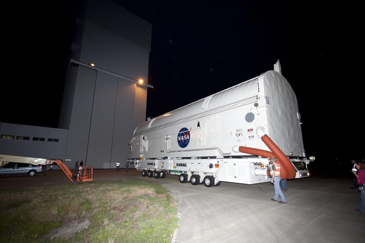 CAPE CANAVERAL, Fla. -- Workers move the payload canister, atop its transporter with the Raffaello multi-purpose logistics module, or MPLM, secured inside, from the Space Station Processing Facility at NASA's Kennedy Space Center in Florida to the Canister Rotation Facility.       Commander Chris Ferguson, Pilot Doug Hurley and Mission Specialists Sandra Magnus and Rex Walheim are targeted to lift off on space shuttle Atlantis July 8, taking with them the MPLM packed with supplies, logistics and spare parts to the International Space Station. The STS-135 mission also will fly a system to investigate the potential for robotically refueling existing spacecraft and return a failed ammonia pump module to help NASA better understand the failure mechanism and improve pump designs for future systems. STS-135 will be the 33rd flight of Atlantis, the 37th shuttle mission to the space station, and the 135th and final mission of NASA's Space Shuttle Program. For more information, visit www.nasa.gov/mission_pages/shuttle/shuttlemissions/sts135/index.html. Photo credit: NASA/Jim Grossmann
