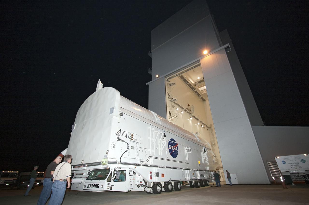 CAPE CANAVERAL, Fla. -- Workers move the payload canister, atop its transporter with the Raffaello multi-purpose logistics module, or MPLM, secured inside, into the Canister Rotation Facility at NASA's Kennedy Space Center in Florida. Commander Chris Ferguson, Pilot Doug Hurley and Mission Specialists Sandra Magnus and Rex Walheim are targeted to lift off on space shuttle Atlantis July 8, taking with them the MPLM packed with supplies, logistics and spare parts to the International Space Station. The STS-135 mission also will fly a system to investigate the potential for robotically refueling existing spacecraft and return a failed ammonia pump module to help NASA better understand the failure mechanism and improve pump designs for future systems. STS-135 will be the 33rd flight of Atlantis, the 37th shuttle mission to the space station, and the 135th and final mission of NASA's Space Shuttle Program. For more information, visit www.nasa.gov/mission_pages/shuttle/shuttlemissions/sts135/index.html. Photo credit: NASA/Jim Grossmann
