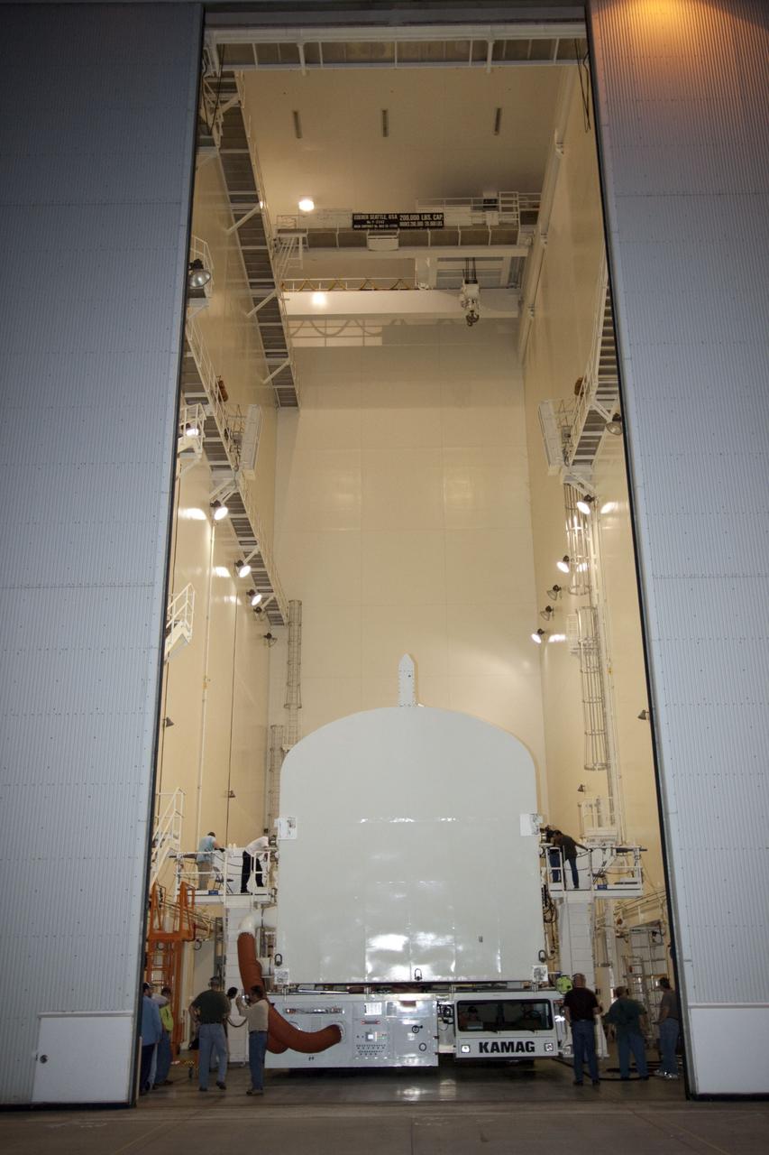 CAPE CANAVERAL, Fla. -- Workers move the payload canister, atop its transporter with the Raffaello multi-purpose logistics module, or MPLM, secured inside, into the Canister Rotation Facility at NASA's Kennedy Space Center in Florida. Commander Chris Ferguson, Pilot Doug Hurley and Mission Specialists Sandra Magnus and Rex Walheim are targeted to lift off on space shuttle Atlantis July 8, taking with them the MPLM packed with supplies, logistics and spare parts to the International Space Station. The STS-135 mission also will fly a system to investigate the potential for robotically refueling existing spacecraft and return a failed ammonia pump module to help NASA better understand the failure mechanism and improve pump designs for future systems. STS-135 will be the 33rd flight of Atlantis, the 37th shuttle mission to the space station, and the 135th and final mission of NASA's Space Shuttle Program. For more information, visit www.nasa.gov/mission_pages/shuttle/shuttlemissions/sts135/index.html. Photo credit: NASA/Jim Grossmann