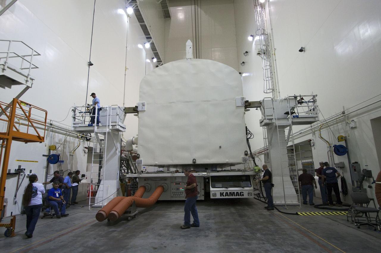 CAPE CANAVERAL, Fla. -- A canister, carrying the Raffaello multi-purpose logistics module, or MPLM, for the STS-135 mission, will be rotated from a horizontal to vertical position in the Canister Rotation Facility at NASA's Kennedy Space Center in Florida. Commander Chris Ferguson, Pilot Doug Hurley and Mission Specialists Sandra Magnus and Rex Walheim are targeted to lift off on space shuttle Atlantis July 8, taking with them the MPLM packed with supplies, logistics and spare parts to the International Space Station. The STS-135 mission also will fly a system to investigate the potential for robotically refueling existing spacecraft and return a failed ammonia pump module to help NASA better understand the failure mechanism and improve pump designs for future systems. STS-135 will be the 33rd flight of Atlantis, the 37th shuttle mission to the space station, and the 135th and final mission of NASA's Space Shuttle Program. For more information, visit www.nasa.gov/mission_pages/shuttle/shuttlemissions/sts135/index.html. Photo credit: NASA/Jack Pfaller