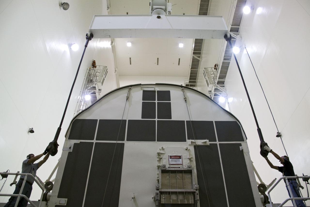 CAPE CANAVERAL, Fla. -- Workers prepare a canister, carrying the Raffaello multi-purpose logistics module, or MPLM, for the STS-135 mission, to be rotated from a horizontal to vertical position in the Canister Rotation Facility at NASA's Kennedy Space Center in Florida. Commander Chris Ferguson, Pilot Doug Hurley and Mission Specialists Sandra Magnus and Rex Walheim are targeted to lift off on space shuttle Atlantis July 8, taking with them the MPLM packed with supplies, logistics and spare parts to the International Space Station. The STS-135 mission also will fly a system to investigate the potential for robotically refueling existing spacecraft and return a failed ammonia pump module to help NASA better understand the failure mechanism and improve pump designs for future systems. STS-135 will be the 33rd flight of Atlantis, the 37th shuttle mission to the space station, and the 135th and final mission of NASA's Space Shuttle Program. For more information, visit www.nasa.gov/mission_pages/shuttle/shuttlemissions/sts135/index.html. Photo credit: NASA/Jack Pfaller