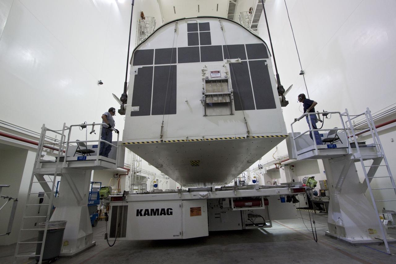 CAPE CANAVERAL, Fla. -- Workers monitor the progress of a canister, carrying the Raffaello multi-purpose logistics module, or MPLM, for the STS-135 mission, as it is rotated from a horizontal to vertical position in the Canister Rotation Facility at NASA's Kennedy Space Center in Florida. Commander Chris Ferguson, Pilot Doug Hurley and Mission Specialists Sandra Magnus and Rex Walheim are targeted to lift off on space shuttle Atlantis July 8, taking with them the MPLM packed with supplies, logistics and spare parts to the International Space Station. The STS-135 mission also will fly a system to investigate the potential for robotically refueling existing spacecraft and return a failed ammonia pump module to help NASA better understand the failure mechanism and improve pump designs for future systems. STS-135 will be the 33rd flight of Atlantis, the 37th shuttle mission to the space station, and the 135th and final mission of NASA's Space Shuttle Program. For more information, visit www.nasa.gov/mission_pages/shuttle/shuttlemissions/sts135/index.html. Photo credit: NASA/Jack Pfaller
