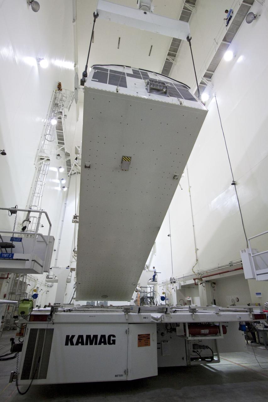 CAPE CANAVERAL, Fla. -- Workers monitor the progress of a canister, carrying the Raffaello multi-purpose logistics module, or MPLM, for the STS-135 mission, as it is rotated from a horizontal to vertical position in the Canister Rotation Facility at NASA's Kennedy Space Center in Florida.     Commander Chris Ferguson, Pilot Doug Hurley and Mission Specialists Sandra Magnus and Rex Walheim are targeted to lift off on space shuttle Atlantis July 8, taking with them the MPLM packed with supplies, logistics and spare parts to the International Space Station. The STS-135 mission also will fly a system to investigate the potential for robotically refueling existing spacecraft and return a failed ammonia pump module to help NASA better understand the failure mechanism and improve pump designs for future systems. STS-135 will be the 33rd flight of Atlantis, the 37th shuttle mission to the space station, and the 135th and final mission of NASA's Space Shuttle Program. For more information, visit www.nasa.gov/mission_pages/shuttle/shuttlemissions/sts135/index.html. Photo credit: NASA/Jack Pfaller