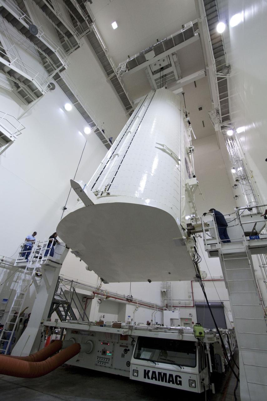 CAPE CANAVERAL, Fla. -- Workers monitor the progress of a canister, carrying the Raffaello multi-purpose logistics module, or MPLM, for the STS-135 mission, as it is rotated from a horizontal to vertical position in the Canister Rotation Facility at NASA's Kennedy Space Center in Florida.     Commander Chris Ferguson, Pilot Doug Hurley and Mission Specialists Sandra Magnus and Rex Walheim are targeted to lift off on space shuttle Atlantis July 8, taking with them the MPLM packed with supplies, logistics and spare parts to the International Space Station. The STS-135 mission also will fly a system to investigate the potential for robotically refueling existing spacecraft and return a failed ammonia pump module to help NASA better understand the failure mechanism and improve pump designs for future systems. STS-135 will be the 33rd flight of Atlantis, the 37th shuttle mission to the space station, and the 135th and final mission of NASA's Space Shuttle Program. For more information, visit www.nasa.gov/mission_pages/shuttle/shuttlemissions/sts135/index.html. Photo credit: NASA/Jack Pfaller