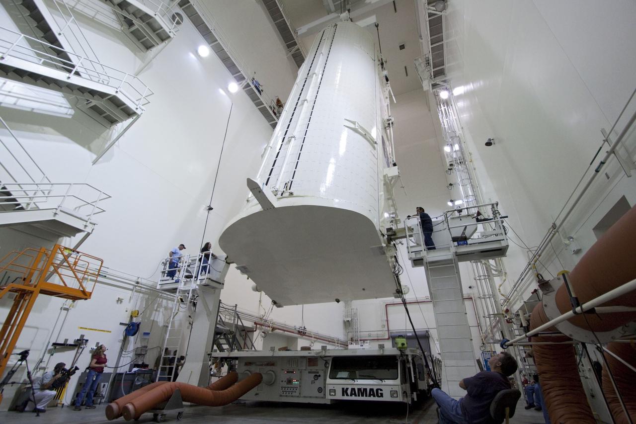 CAPE CANAVERAL, Fla. -- Workers monitor the progress of a canister, carrying the Raffaello multi-purpose logistics module, or MPLM, for the STS-135 mission, as it is rotated from a horizontal to vertical position in the Canister Rotation Facility at NASA's Kennedy Space Center in Florida.     Commander Chris Ferguson, Pilot Doug Hurley and Mission Specialists Sandra Magnus and Rex Walheim are targeted to lift off on space shuttle Atlantis July 8, taking with them the MPLM packed with supplies, logistics and spare parts to the International Space Station. The STS-135 mission also will fly a system to investigate the potential for robotically refueling existing spacecraft and return a failed ammonia pump module to help NASA better understand the failure mechanism and improve pump designs for future systems. STS-135 will be the 33rd flight of Atlantis, the 37th shuttle mission to the space station, and the 135th and final mission of NASA's Space Shuttle Program. For more information, visit www.nasa.gov/mission_pages/shuttle/shuttlemissions/sts135/index.html. Photo credit: NASA/Jack Pfaller