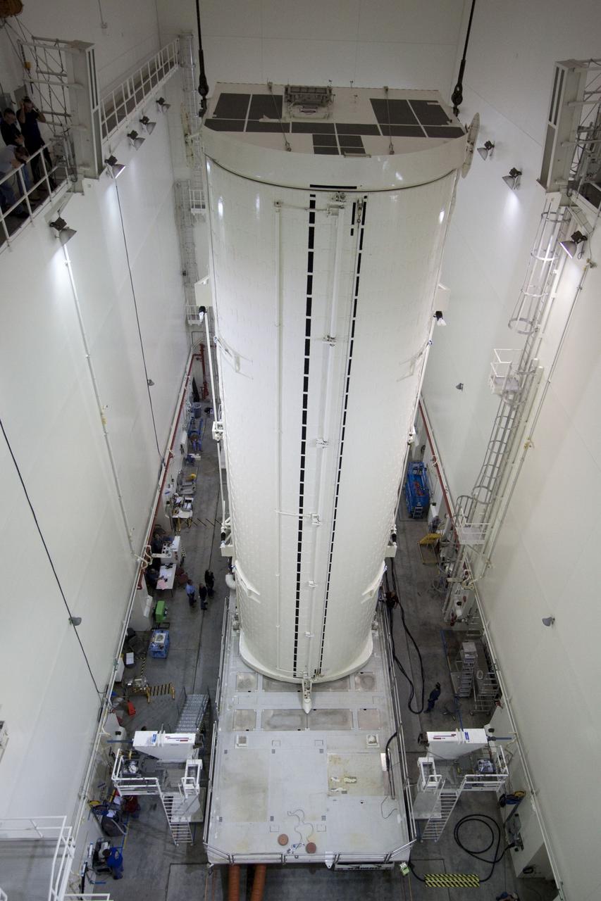 CAPE CANAVERAL, Fla. -- After being rotated from a horizontal to vertical position, the canister that contains the Raffaello multi-purpose logistics module, or MPLM, for the STS-135 mission, has been lowered onto a transportation vehicle in the Canister Rotation Facility at NASA's Kennedy Space Center in Florida.     Commander Chris Ferguson, Pilot Doug Hurley and Mission Specialists Sandra Magnus and Rex Walheim are targeted to lift off on space shuttle Atlantis July 8, taking with them the MPLM packed with supplies, logistics and spare parts to the International Space Station. The STS-135 mission also will fly a system to investigate the potential for robotically refueling existing spacecraft and return a failed ammonia pump module to help NASA better understand the failure mechanism and improve pump designs for future systems. STS-135 will be the 33rd flight of Atlantis, the 37th shuttle mission to the space station, and the 135th and final mission of NASA's Space Shuttle Program. For more information, visit www.nasa.gov/mission_pages/shuttle/shuttlemissions/sts135/index.html. Photo credit: NASA/Jack Pfaller