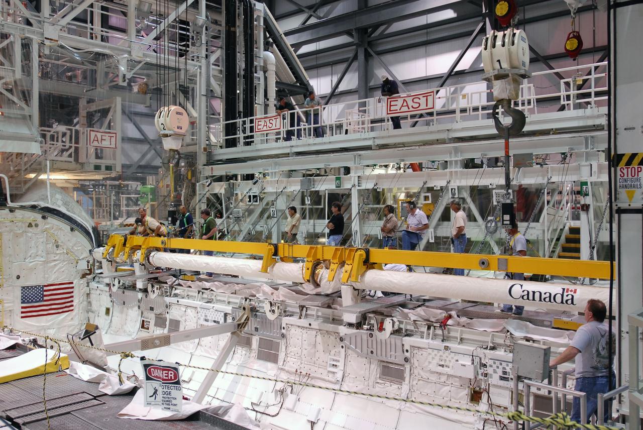 CAPE CANAVERAL, Fla. -- In Orbiter Processing Facility-1 at NASA's Kennedy Space Center in Florida, workers disconnect the remote manipulator system, or RMS, from space shuttle Endeavour's payload bay.    The removal is part of Endeavour's transition and retirement processing. Endeavour is being prepared for public display at the California Science Center in Los Angeles. Endeavour flew 25 missions, spent 299 days in space, orbited Earth 4,671 times and traveled 122,883,151 miles over the course of its 19-year career.  Photo credit: NASA/Tim Jacobs