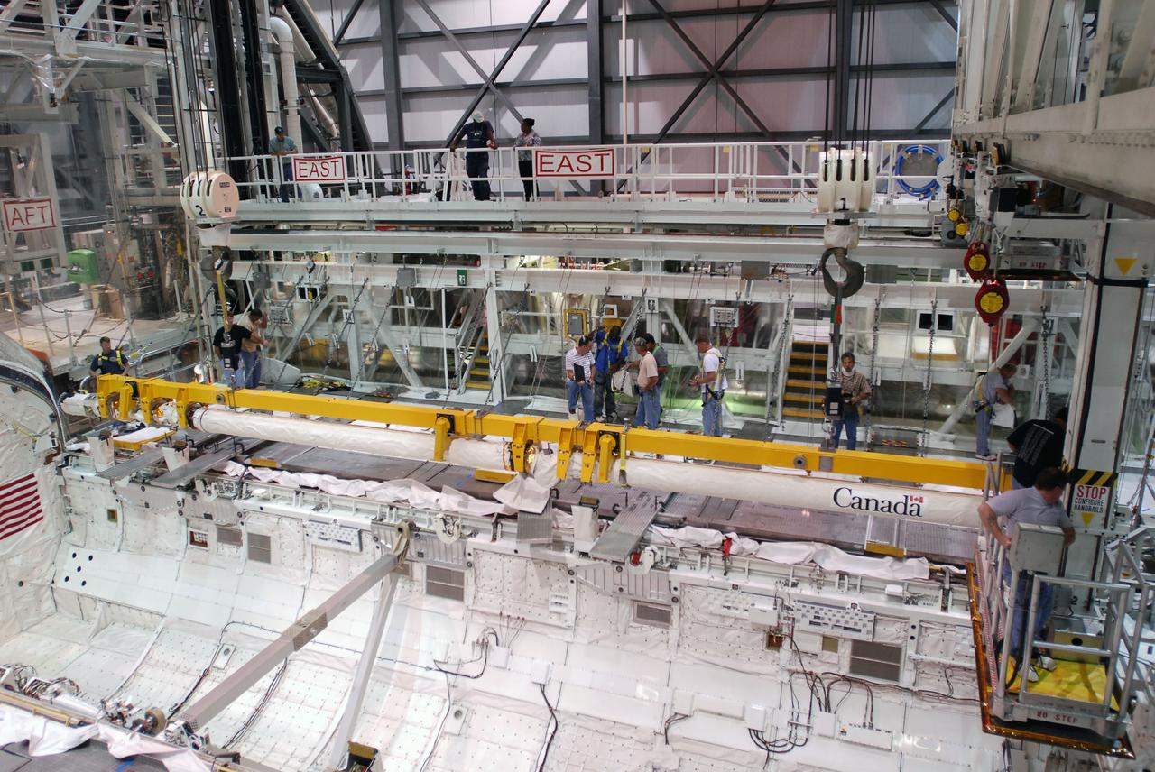 CAPE CANAVERAL, Fla. -- In Orbiter Processing Facility-1 at NASA's Kennedy Space Center in Florida, a crane is attached to the remote manipulator system, or RMS, in space shuttle Endeavour's payload bay.    The removal is part of Endeavour's transition and retirement processing. Endeavour is being prepared for public display at the California Science Center in Los Angeles. Endeavour flew 25 missions, spent 299 days in space, orbited Earth 4,671 times and traveled 122,883,151 miles over the course of its 19-year career.  Photo credit: NASA/Tim Jacobs