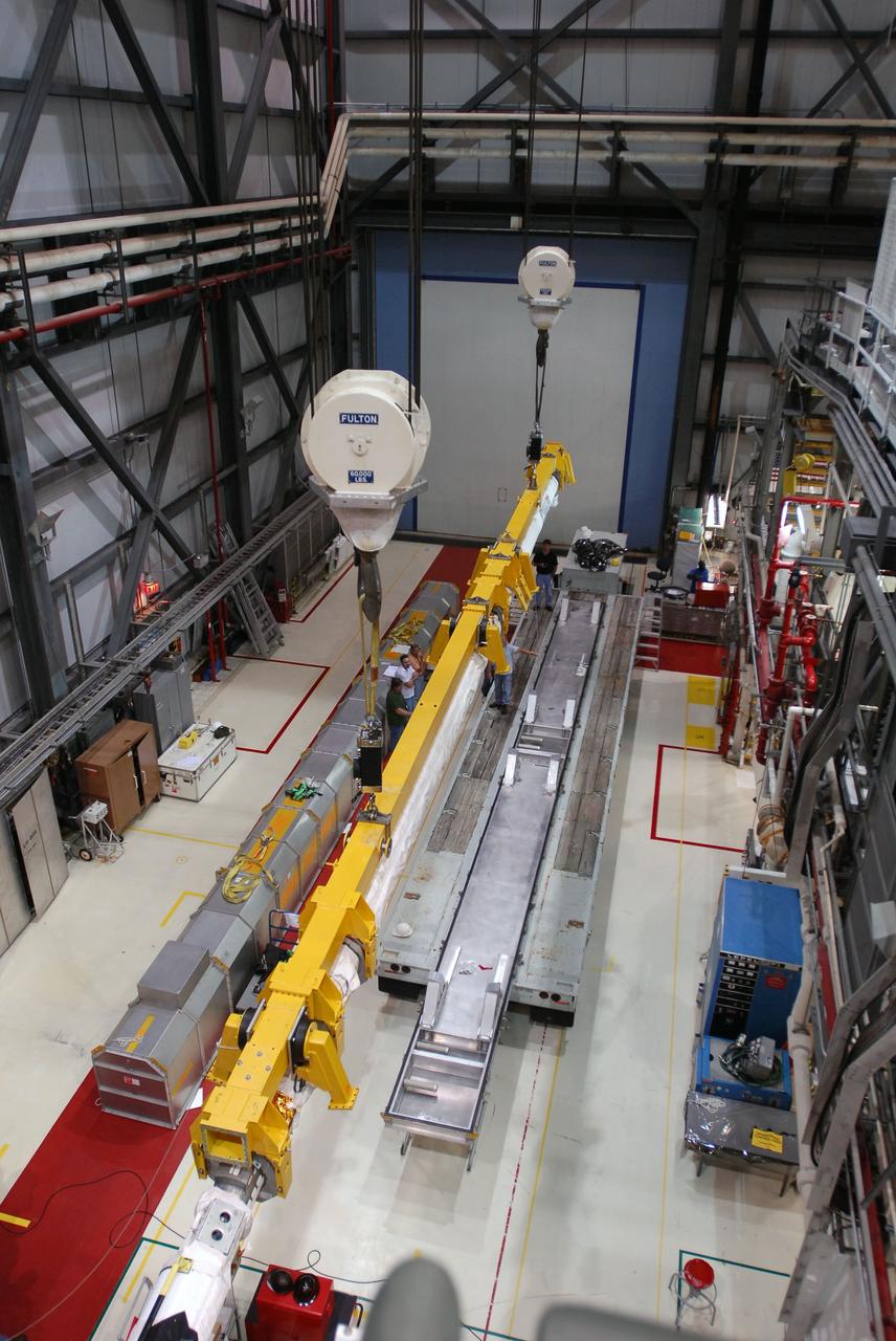 CAPE CANAVERAL, Fla. -- In Orbiter Processing Facility-1 at NASA's Kennedy Space Center in Florida, the remote manipulator system, or RMS, is lifted toward a transportation canister following removal from space shuttle Endeavour's payload bay.     The removal is part of Endeavour's transition and retirement processing. Endeavour is being prepared for public display at the California Science Center in Los Angeles. Endeavour flew 25 missions, spent 299 days in space, orbited Earth 4,671 times and traveled 122,883,151 miles over the course of its 19-year career.  Photo credit: NASA/Tim Jacobs