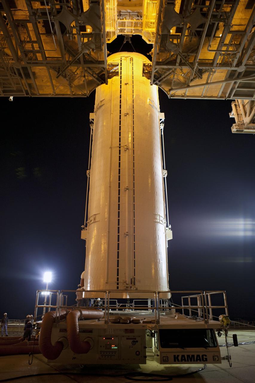 CAPE CANAVERAL, Fla. -- An overhead crane lifts the canister carrying the Raffaello multi-purpose logistics module (MPLM) off its transporter to the payload changeout room. The payload was delivered to Launch Pad 39A at NASA's Kennedy Space Center in Florida for space shuttle Atlantis' STS-135 mission to the International Space Station. The payload ground-handling mechanism then will be used to transfer Raffaello out of the canister into Atlantis' payload bay. Next, the rotating service structure that protects the shuttle from the elements and provides access will be rotated back into place.        Commander Chris Ferguson, Pilot Doug Hurley and Mission Specialists Sandra Magnus and Rex Walheim are targeted to lift off on Atlantis July 8, taking with them the MPLM packed with supplies, logistics and spare parts to the station. The STS-135 mission also will fly a system to investigate the potential for robotically refueling existing satellites and return a failed ammonia pump module to help NASA better understand the failure mechanism and improve pump designs for future systems. STS-135 will be the 33rd flight of Atlantis, the 37th shuttle mission to the space station, and the 135th and final mission of NASA's Space Shuttle Program. For more information visit, www.nasa.gov/mission_pages/shuttle/shuttlemissions/sts135/index.html. Photo credit: NASA/Dimitri Gerondidakis