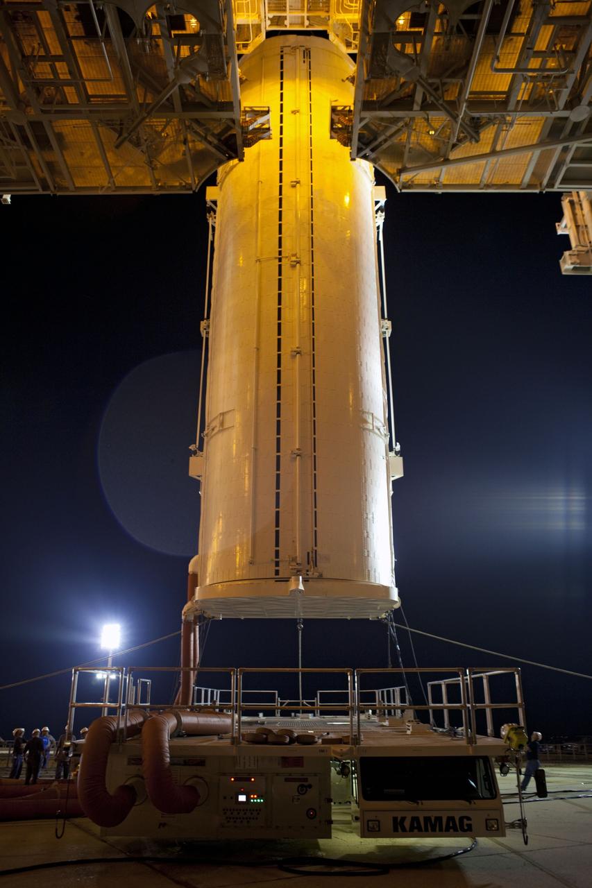 CAPE CANAVERAL, Fla. -- The payload canister carrying the Raffaello multi-purpose logistics module (MPLM) is lifted to the payload changeout room on the rotating service structure (RSS) on Launch Pad 39A at NASA's Kennedy Space Center in Florida. Umbilical hoses, maintaining a controlled environment for the cargo are attached to the lower end of the canister. The payload ground-handling mechanism then will be used to transfer Raffaello out of the canister into Atlantis' payload bay. Next, the RSS that protects the shuttle from the elements and provides access will be rotated back into place.            Commander Chris Ferguson, Pilot Doug Hurley and Mission Specialists Sandra Magnus and Rex Walheim are targeted to lift off on Atlantis July 8, taking with them the MPLM packed with supplies, logistics and spare parts to the station. The STS-135 mission also will fly a system to investigate the potential for robotically refueling existing satellites and return a failed ammonia pump module to help NASA better understand the failure mechanism and improve pump designs for future systems. STS-135 will be the 33rd flight of Atlantis, the 37th shuttle mission to the space station, and the 135th and final mission of NASA's Space Shuttle Program. For more information visit, www.nasa.gov/mission_pages/shuttle/shuttlemissions/sts135/index.html. Photo credit: NASA/Dimitri Gerondidakis