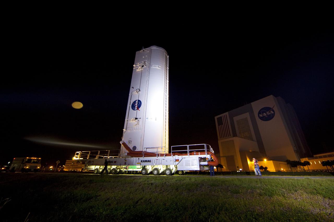 CAPE CANAVERAL, Fla. -- The container that carries the Raffaello multi-purpose logistics module (MPLM), secured on its transportation vehicle, makes its way past the Vehicle Assembly Building to Launch Pad 39A at NASA's Kennedy Space Center in Florida. Once there, the canister will be lifted to the payload changeout room. The payload ground-handling mechanism then will be used to transfer Raffaello out of the canister into space shuttle Atlantis' payload bay. Next, the rotating service structure that protects the shuttle from the elements and provides access will be rotated back into place.                Commander Chris Ferguson, Pilot Doug Hurley and Mission Specialists Sandra Magnus and Rex Walheim are targeted to lift off on Atlantis July 8, taking with them the MPLM packed with supplies, logistics and spare parts to the station. The STS-135 mission also will fly a system to investigate the potential for robotically refueling existing satellites and return a failed ammonia pump module to help NASA better understand the failure mechanism and improve pump designs for future systems. STS-135 will be the 33rd flight of Atlantis, the 37th shuttle mission to the space station, and the 135th and final mission of NASA's Space Shuttle Program. For more information visit, www.nasa.gov/mission_pages/shuttle/shuttlemissions/sts135/index.html. Photo credit: NASA/Frank Michaux