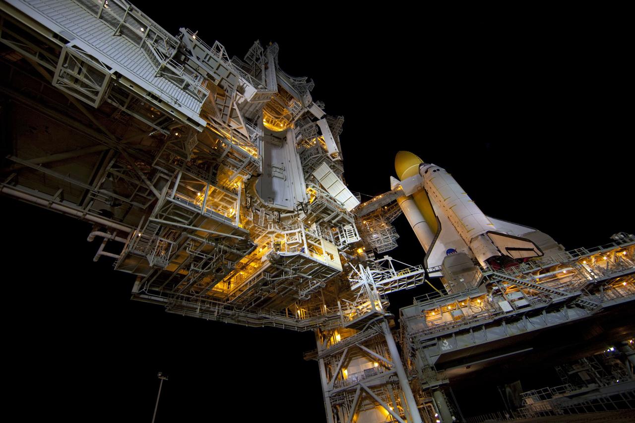CAPE CANAVERAL, Fla. -- A canister, carrying the Raffaello multi-purpose logistics module (MPLM) for space shuttle Atlantis' STS-135 mission to the International Space Station, arrives at Launch Pad 39A at NASA's Kennedy Space Center in Florida. The canister will be lifted to the payload changeout room (seen here center of image). The payload ground-handling mechanism then will be used to transfer Raffaello out of the canister into Atlantis' payload bay. Next, the rotating service structure that protects the shuttle from the elements and provides access will be rotated back into place.            Commander Chris Ferguson, Pilot Doug Hurley and Mission Specialists Sandra Magnus and Rex Walheim are targeted to lift off on Atlantis July 8, taking with them the MPLM packed with supplies, logistics and spare parts to the station. The STS-135 mission also will fly a system to investigate the potential for robotically refueling existing satellites and return a failed ammonia pump module to help NASA better understand the failure mechanism and improve pump designs for future systems. STS-135 will be the 33rd flight of Atlantis, the 37th shuttle mission to the space station, and the 135th and final mission of NASA's Space Shuttle Program. For more information visit, www.nasa.gov/mission_pages/shuttle/shuttlemissions/sts135/index.html. Photo credit: NASA/Frank Michaux