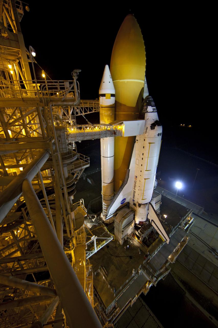 CAPE CANAVERAL, Fla. -- On Launch Pad 39A at NASA's Kennedy Space Center in Florida, the access arm supporting the pad's White Room is in place against space shuttle Atlantis. The room provides workers and astronauts an entry point to the shuttle's crew compartment. The Raffaello multi-purpose logistics module (MPLM) payload for space shuttle Atlantis' STS-135 mission to the International Space Station has arrived at the pad. The payload canister will be lifted to the payload changeout room and the payload ground-handling mechanism then will be used to transfer Raffaello out of the canister into Atlantis' payload bay. Next, the rotating service structure that protects the shuttle from the elements and provides access will be rotated back into place.            Commander Chris Ferguson, Pilot Doug Hurley and Mission Specialists Sandra Magnus and Rex Walheim are targeted to lift off on Atlantis July 8, taking with them the MPLM packed with supplies, logistics and spare parts to the station. The STS-135 mission also will fly a system to investigate the potential for robotically refueling existing satellites and return a failed ammonia pump module to help NASA better understand the failure mechanism and improve pump designs for future systems. STS-135 will be the 33rd flight of Atlantis, the 37th shuttle mission to the space station, and the 135th and final mission of NASA's Space Shuttle Program. For more information visit, www.nasa.gov/mission_pages/shuttle/shuttlemissions/sts135/index.html. Photo credit: NASA/Frank Michaux