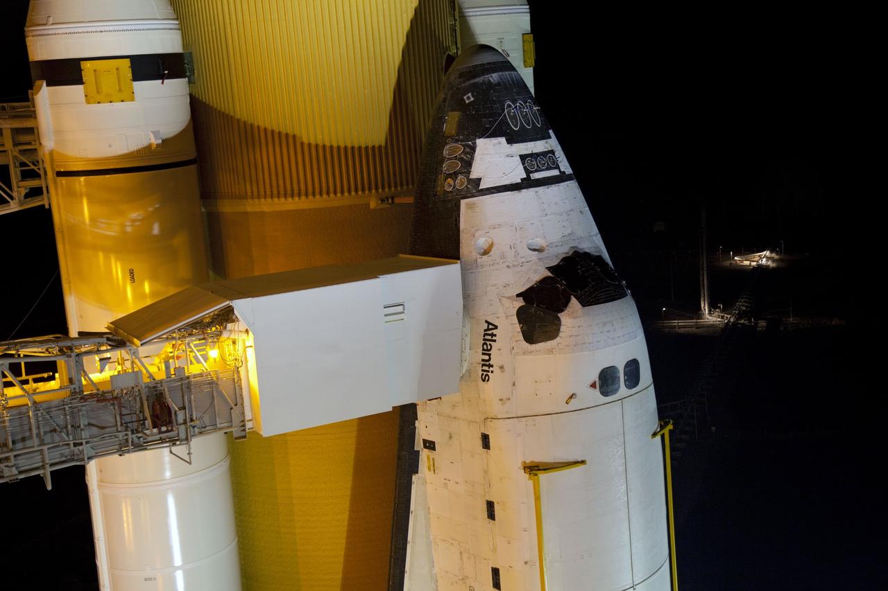 CAPE CANAVERAL, Fla. -- On Launch Pad 39A at NASA's Kennedy Space Center in Florida, the access arm supporting the pad's White Room is in place against space shuttle Atlantis. The room provides workers and astronauts an entry point to the shuttle's crew compartment. The Raffaello multi-purpose logistics module (MPLM) payload for space shuttle Atlantis' STS-135 mission to the International Space Station has arrived at the pad. The payload canister will be lifted to the payload changeout room and the payload ground-handling mechanism then will be used to transfer Raffaello out of the canister into Atlantis' payload bay. Next, the rotating service structure that protects the shuttle from the elements and provides access will be rotated back into place.            Commander Chris Ferguson, Pilot Doug Hurley and Mission Specialists Sandra Magnus and Rex Walheim are targeted to lift off on Atlantis July 8, taking with them the MPLM packed with supplies, logistics and spare parts to the station. The STS-135 mission also will fly a system to investigate the potential for robotically refueling existing satellites and return a failed ammonia pump module to help NASA better understand the failure mechanism and improve pump designs for future systems. STS-135 will be the 33rd flight of Atlantis, the 37th shuttle mission to the space station, and the 135th and final mission of NASA's Space Shuttle Program. For more information visit, www.nasa.gov/mission_pages/shuttle/shuttlemissions/sts135/index.html. Photo credit: NASA/Frank Michaux