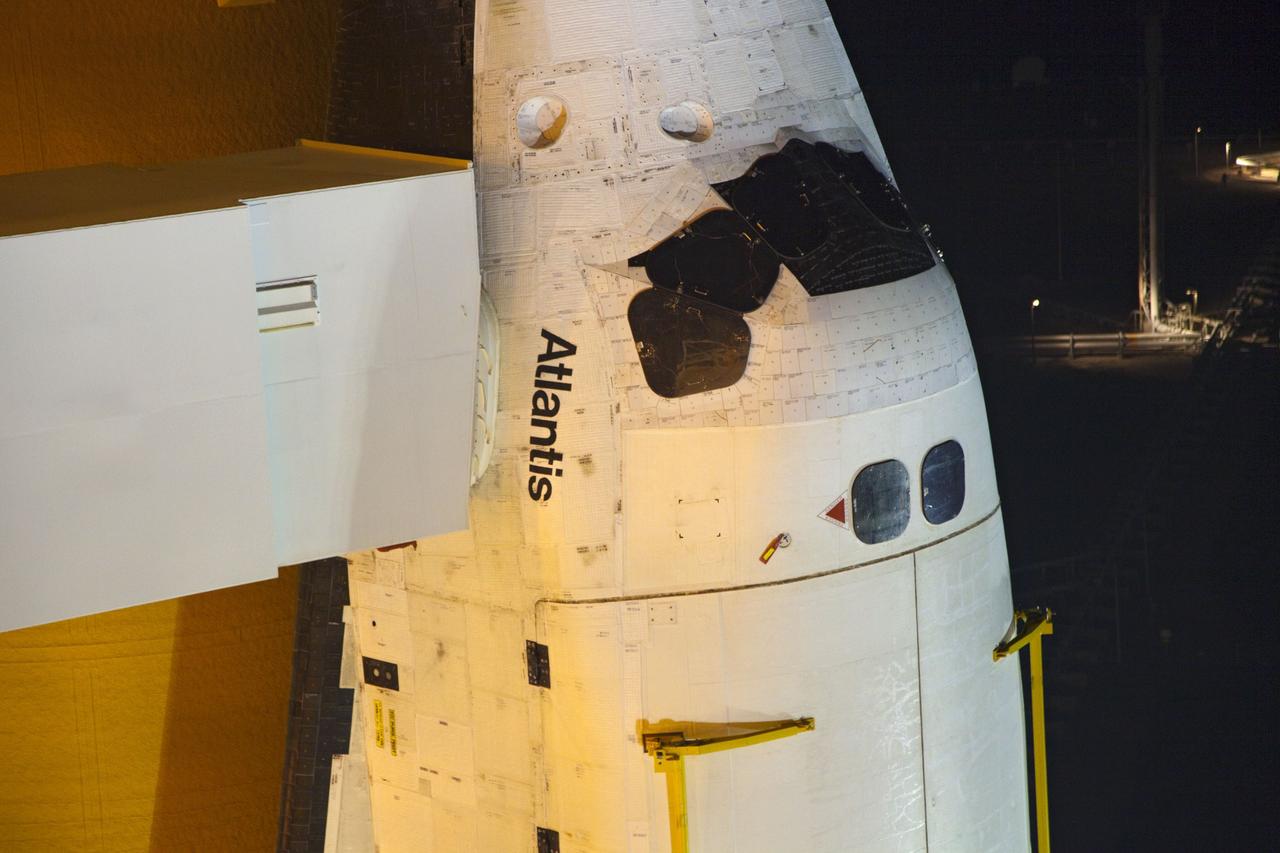 CAPE CANAVERAL, Fla. -- On Launch Pad 39A at NASA's Kennedy Space Center in Florida, the access arm supporting the pad's White Room is in place against space shuttle Atlantis. The room provides workers and astronauts an entry point to the shuttle's crew compartment. The Raffaello multi-purpose logistics module (MPLM) payload for space shuttle Atlantis' STS-135 mission to the International Space Station has arrived at the pad. The payload canister will be lifted to the payload changeout room and the payload ground-handling mechanism then will be used to transfer Raffaello out of the canister into Atlantis' payload bay. Next, the rotating service structure that protects the shuttle from the elements and provides access will be rotated back into place.            Commander Chris Ferguson, Pilot Doug Hurley and Mission Specialists Sandra Magnus and Rex Walheim are targeted to lift off on Atlantis July 8, taking with them the MPLM packed with supplies, logistics and spare parts to the station. The STS-135 mission also will fly a system to investigate the potential for robotically refueling existing satellites and return a failed ammonia pump module to help NASA better understand the failure mechanism and improve pump designs for future systems. STS-135 will be the 33rd flight of Atlantis, the 37th shuttle mission to the space station, and the 135th and final mission of NASA's Space Shuttle Program. For more information visit, www.nasa.gov/mission_pages/shuttle/shuttlemissions/sts135/index.html. Photo credit: NASA/Frank Michaux