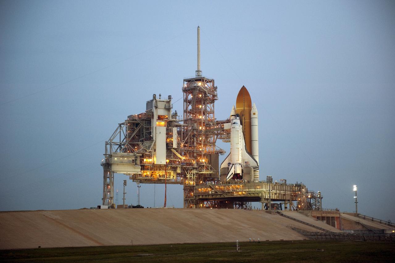 CAPE CANAVERAL, Fla. -- Sunrise at NASA's Kennedy Space Center in Florida finds space shuttle Atlantis on Launch Pad 39A after the payload canister carrying the Raffaello multi-purpose logistics module (MPLM) was lifted into the payload changeout room. The payload ground-handling mechanism then will be used to transfer Raffaello out of the canister into Atlantis' payload bay. Next, the rotating service structure that protects the shuttle from the elements and provides access will be rotated back into place.              Commander Chris Ferguson, Pilot Doug Hurley and Mission Specialists Sandra Magnus and Rex Walheim are targeted to lift off on space shuttle Atlantis July 8, taking with them the MPLM packed with supplies, logistics and spare parts to the International Space Station. The STS-135 mission also will fly a system to investigate the potential for robotically refueling existing satellites and return a failed ammonia pump module to help NASA better understand the failure mechanism and improve pump designs for future systems. STS-135 will be the 33rd flight of Atlantis, the 37th shuttle mission to the space station, and the 135th and final mission of NASA's Space Shuttle Program. For more information visit, www.nasa.gov/mission_pages/shuttle/shuttlemissions/sts135/index.html. Photo credit: NASA/Kim Shiflett