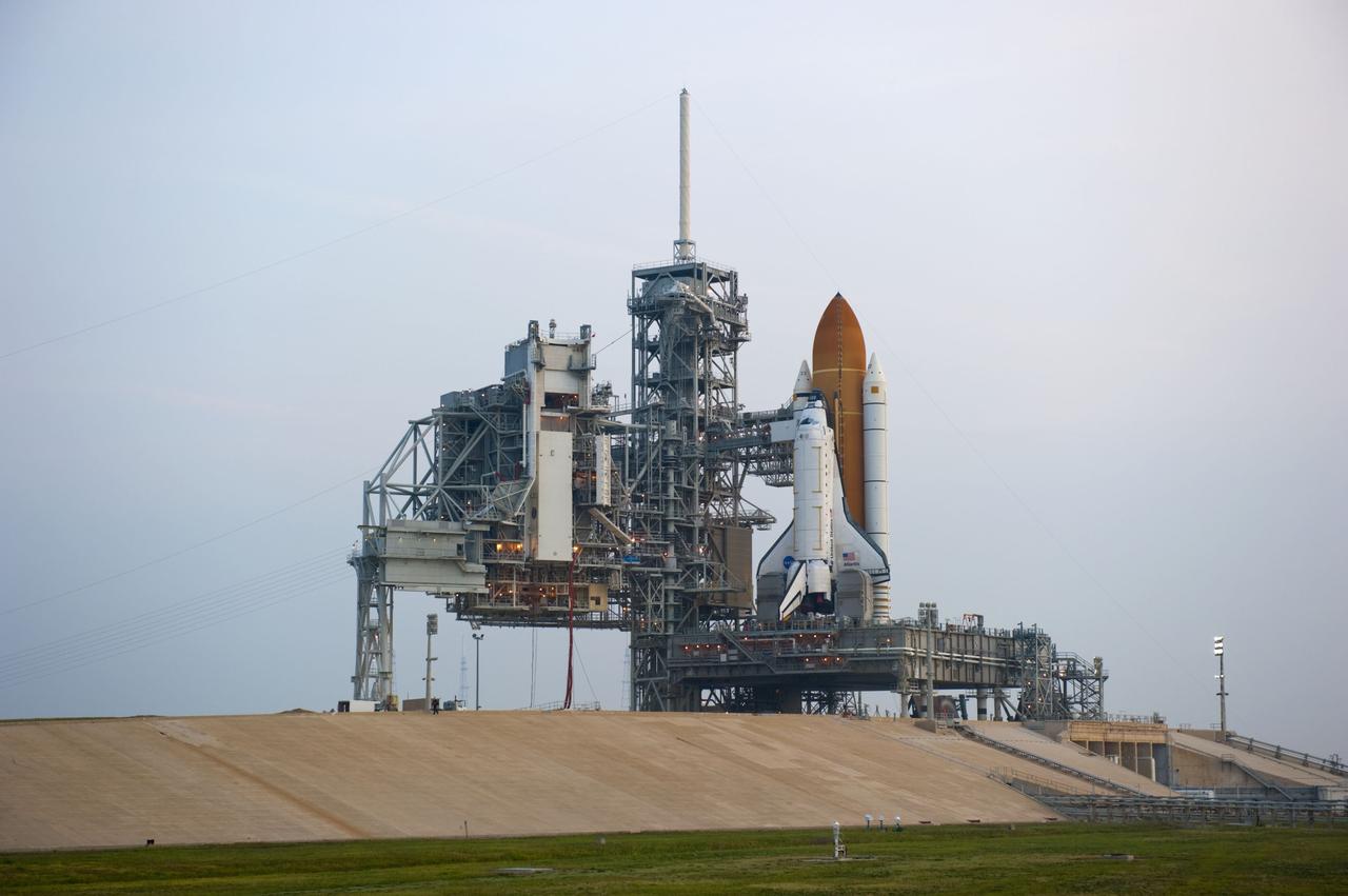 CAPE CANAVERAL, Fla. -- Sunrise at NASA's Kennedy Space Center in Florida finds space shuttle Atlantis on Launch Pad 39A after the payload canister carrying the Raffaello multi-purpose logistics module (MPLM) was lifted into the payload changeout room. The payload ground-handling mechanism then will be used to transfer Raffaello out of the canister into Atlantis' payload bay. Next, the rotating service structure that protects the shuttle from the elements and provides access will be rotated back into place.                Commander Chris Ferguson, Pilot Doug Hurley and Mission Specialists Sandra Magnus and Rex Walheim are targeted to lift off on space shuttle Atlantis July 8, taking with them the MPLM packed with supplies, logistics and spare parts to the International Space Station. The STS-135 mission also will fly a system to investigate the potential for robotically refueling existing satellites and return a failed ammonia pump module to help NASA better understand the failure mechanism and improve pump designs for future systems. STS-135 will be the 33rd flight of Atlantis, the 37th shuttle mission to the space station, and the 135th and final mission of NASA's Space Shuttle Program. For more information visit, www.nasa.gov/mission_pages/shuttle/shuttlemissions/sts135/index.html. Photo credit: NASA/Kim Shiflett
