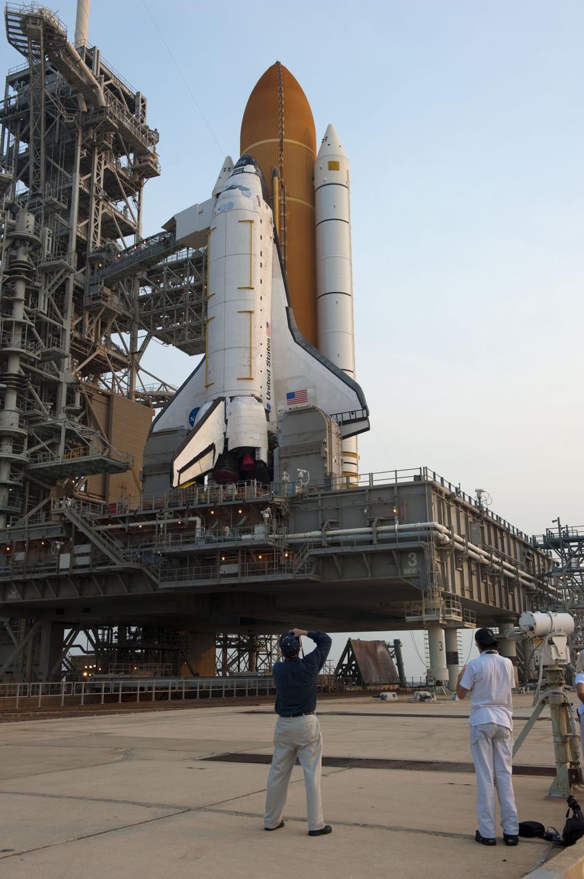 CAPE CANAVERAL, Fla. -- At NASA's Kennedy Space Center in Florida media snap photos of space shuttle Atlantis on Launch Pad 39A after the payload canister carrying the Raffaello multi-purpose logistics module (MPLM) was lifted into the payload changeout room on the rotating service structure.      Commander Chris Ferguson, Pilot Doug Hurley and Mission Specialists Sandra Magnus and Rex Walheim are targeted to lift off on space shuttle Atlantis July 8, taking with them the MPLM packed with supplies, logistics and spare parts to the International Space Station. The STS-135 mission also will fly a system to investigate the potential for robotically refueling existing satellites and return a failed ammonia pump module to help NASA better understand the failure mechanism and improve pump designs for future systems. STS-135 will be the 33rd flight of Atlantis, the 37th shuttle mission to the space station, and the 135th and final mission of NASA's Space Shuttle Program. For more information visit, www.nasa.gov/mission_pages/shuttle/shuttlemissions/sts135/index.html. Photo credit: NASA/Kim Shiflett