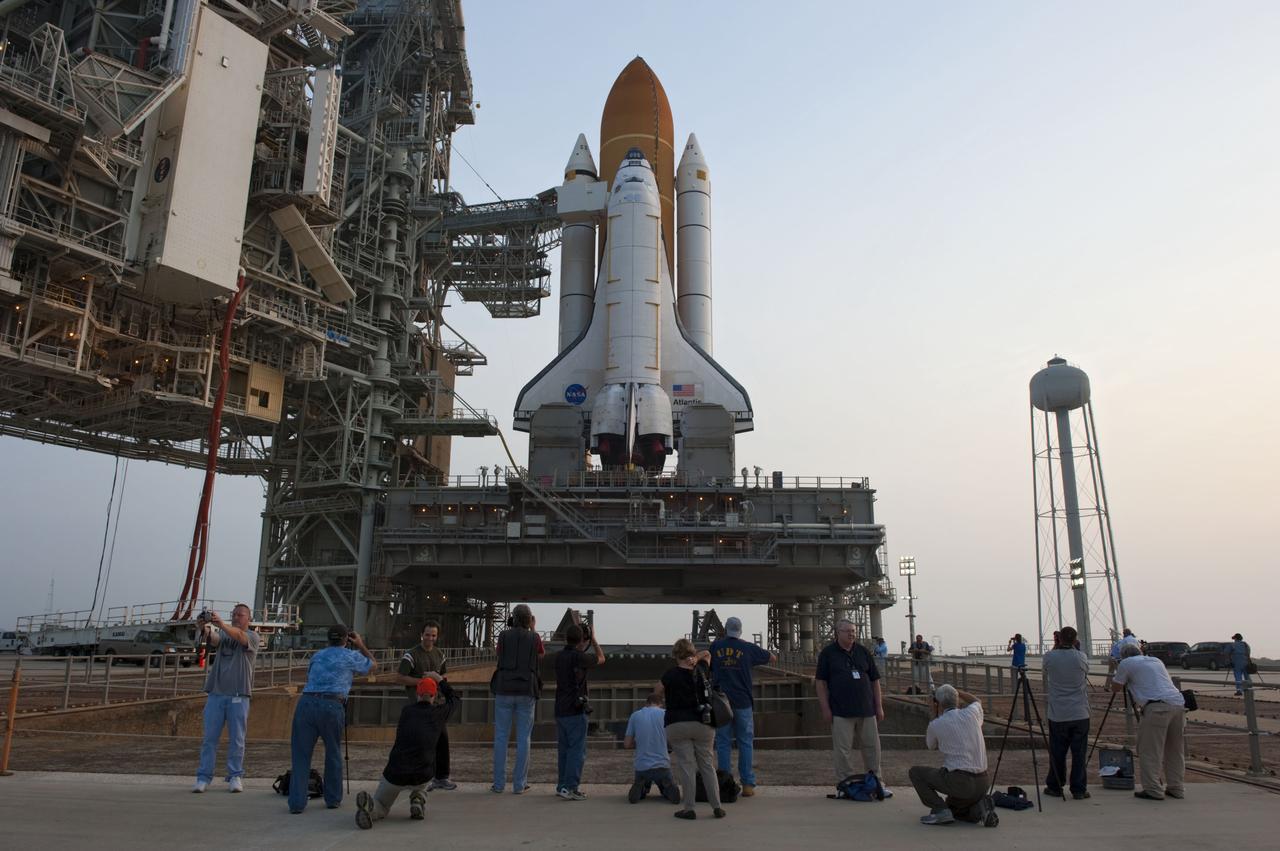 CAPE CANAVERAL, Fla. -- At NASA's Kennedy Space Center in Florida media snap photos of space shuttle Atlantis on Launch Pad 39A after the payload canister carrying the Raffaello multi-purpose logistics module (MPLM) was lifted into the payload changeout room on the rotating service structure.      Commander Chris Ferguson, Pilot Doug Hurley and Mission Specialists Sandra Magnus and Rex Walheim are targeted to lift off on space shuttle Atlantis July 8, taking with them the MPLM packed with supplies, logistics and spare parts to the International Space Station. The STS-135 mission also will fly a system to investigate the potential for robotically refueling existing satellites and return a failed ammonia pump module to help NASA better understand the failure mechanism and improve pump designs for future systems. STS-135 will be the 33rd flight of Atlantis, the 37th shuttle mission to the space station, and the 135th and final mission of NASA's Space Shuttle Program. For more information visit, www.nasa.gov/mission_pages/shuttle/shuttlemissions/sts135/index.html. Photo credit: NASA/Kim Shiflett