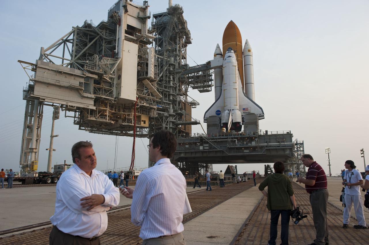 CAPE CANAVERAL, Fla. -- On Launch Pad 39A at NASA's Kennedy Space Center in Florida, Payload Mission Manager Joe Delai speaks to media after the payload canister carrying the Raffaello multi-purpose logistics module (MPLM) was delivered to the pad for space shuttle Atlantis' STS-135 mission, and lifted into the payload changeout room on the rotating service structure.         Commander Chris Ferguson, Pilot Doug Hurley and Mission Specialists Sandra Magnus and Rex Walheim are targeted to lift off on space shuttle Atlantis July 8, taking with them the MPLM packed with supplies, logistics and spare parts to the International Space Station. The STS-135 mission also will fly a system to investigate the potential for robotically refueling existing satellites and return a failed ammonia pump module to help NASA better understand the failure mechanism and improve pump designs for future systems. STS-135 will be the 33rd flight of Atlantis, the 37th shuttle mission to the space station, and the 135th and final mission of NASA's Space Shuttle Program. For more information visit, www.nasa.gov/mission_pages/shuttle/shuttlemissions/sts135/index.html. Photo credit: NASA/Kim Shiflett