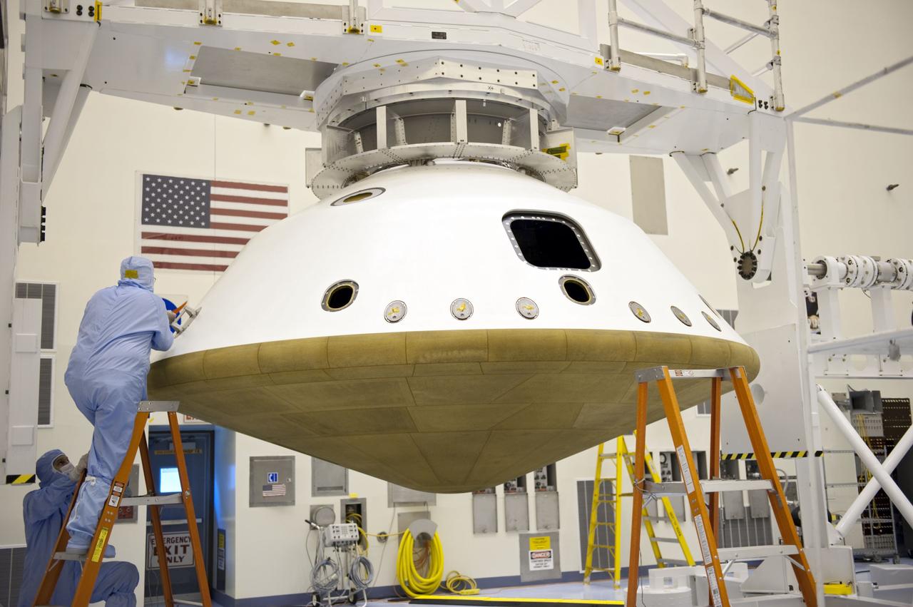 Cape Canaveral, Fla. -- At the Payload Hazardous Servicing Facility at NASA's Kennedy Space Center in Florida, technicians prepare to separate the two components of the aeroshell, an element of NASA's Mars Science Laboratory (MSL), after testing. The aeroshell consists of the spacecraft's heat shield and the backshell which carries the parachute and several components used during later stages of entry, descent and landing. MSL's components include a compact car-sized rover, Curiosity, which has 10 science instruments designed to search for evidence on whether Mars has had environments favorable to microbial life, including chemical ingredients for life. The unique rover will use a laser to look inside rocks and release its gasses so that the rover’s spectrometer can analyze and send the data back to Earth. Launch of MSL aboard a United Launch Alliance Atlas V rocket is scheduled for Nov. 25 from Space Launch Complex 41 on Cape Canaveral Air Force Station in Florida. For more information, visit http://www.nasa.gov/msl. Photo credit: NASA/Kim Shiflett