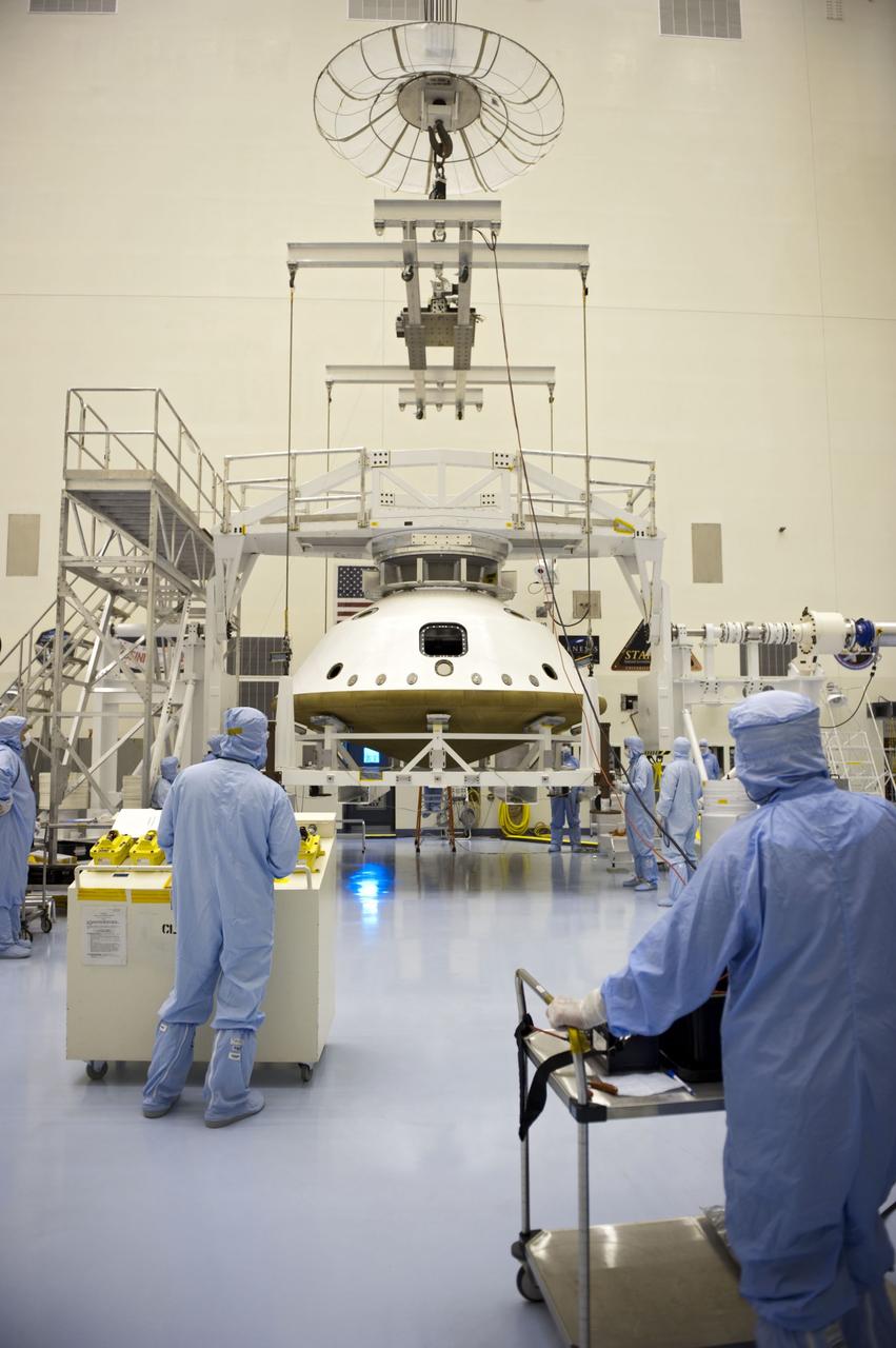Cape Canaveral, Fla. -- At the Payload Hazardous Servicing Facility at NASA's Kennedy Space Center in Florida, technicians, attaching an overhead crane, prepare to separate the two components of the aeroshell, an element of NASA's Mars Science Laboratory (MSL), after testing. The aeroshell consists of the spacecraft's heat shield and the backshell which carries the parachute and several components used during later stages of entry, descent and landing. MSL's components include a compact car-sized rover, Curiosity, which has 10 science instruments designed to search for evidence on whether Mars has had environments favorable to microbial life, including chemical ingredients for life. The unique rover will use a laser to look inside rocks and release its gasses so that the rover’s spectrometer can analyze and send the data back to Earth. Launch of MSL aboard a United Launch Alliance Atlas V rocket is scheduled for Nov. 25 from Space Launch Complex 41 on Cape Canaveral Air Force Station in Florida. For more information, visit http://www.nasa.gov/msl. Photo credit: NASA/Kim Shiflett