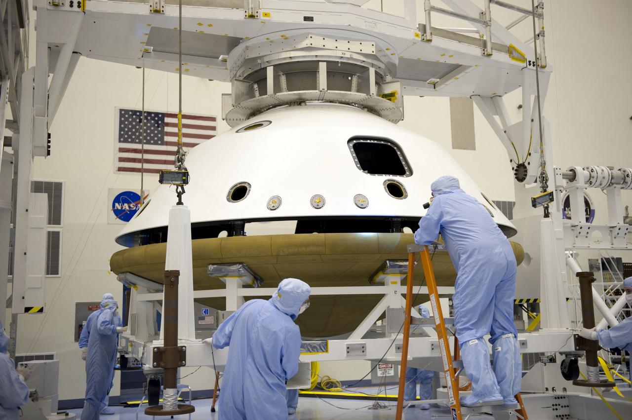 Cape Canaveral, Fla. -- At the Payload Hazardous Servicing Facility at NASA's Kennedy Space Center in Florida, technicians, using an overhead crane, separate the two components of the aeroshell, an element of NASA's Mars Science Laboratory (MSL), after testing. The aeroshell consists of the spacecraft's heat shield and the backshell which carries the parachute and several components used during later stages of entry, descent and landing. MSL's components include a compact car-sized rover, Curiosity, which has 10 science instruments designed to search for evidence on whether Mars has had environments favorable to microbial life, including chemical ingredients for life. The unique rover will use a laser to look inside rocks and release its gasses so that the rover’s spectrometer can analyze and send the data back to Earth. Launch of MSL aboard a United Launch Alliance Atlas V rocket is scheduled for Nov. 25 from Space Launch Complex 41 on Cape Canaveral Air Force Station in Florida. For more information, visit http://www.nasa.gov/msl. Photo credit: NASA/Kim Shiflett