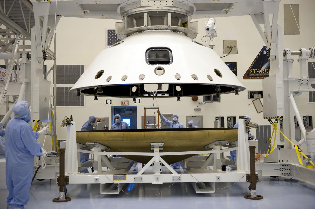 Cape Canaveral, Fla. -- At the Payload Hazardous Servicing Facility at NASA's Kennedy Space Center in Florida, technicians, using an overhead crane, separate the two components of the aeroshell, an element of NASA's Mars Science Laboratory (MSL), after testing. The aeroshell consists of the spacecraft's heat shield and the backshell which carries the parachute and several components used during later stages of entry, descent and landing. MSL's components include a compact car-sized rover, Curiosity, which has 10 science instruments designed to search for evidence on whether Mars has had environments favorable to microbial life, including chemical ingredients for life. The unique rover will use a laser to look inside rocks and release its gasses so that the rover’s spectrometer can analyze and send the data back to Earth. Launch of MSL aboard a United Launch Alliance Atlas V rocket is scheduled for Nov. 25 from Space Launch Complex 41 on Cape Canaveral Air Force Station in Florida. For more information, visit http://www.nasa.gov/msl. Photo credit: NASA/Kim Shiflett