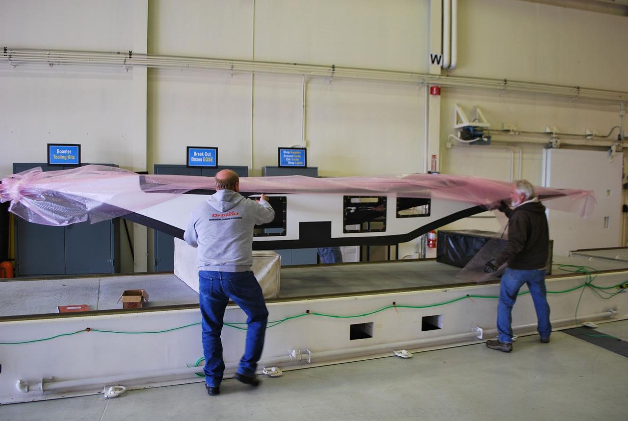 VANDENBERG AIR FORCE BASE, Calif. -- At Vandenberg Air Force Base in California, Orbital Sciences Corp. workers uncrate the fillet (the wings of the Pegasus XL launch vehicle) for inspection. The Pegasus rocket is being processed to launch the Nuclear Spectroscopic Telescope Array (NuSTAR) into space.        After the rocket and spacecraft are processed at Vandenberg, they will be flown on the Orbital Sciences' L-1011 carrier aircraft to the Ronald Reagan Ballistic Missile Defense Test Site located at the Pacific Ocean’s Kwajalein Atoll for launch. The high-energy X-ray telescope will conduct a census for black holes, map radioactive material in young supernovae remnants, and study the origins of cosmic rays and the extreme physics around collapsed stars. Photo credit: NASA/Randy Beaudoin, VAFB