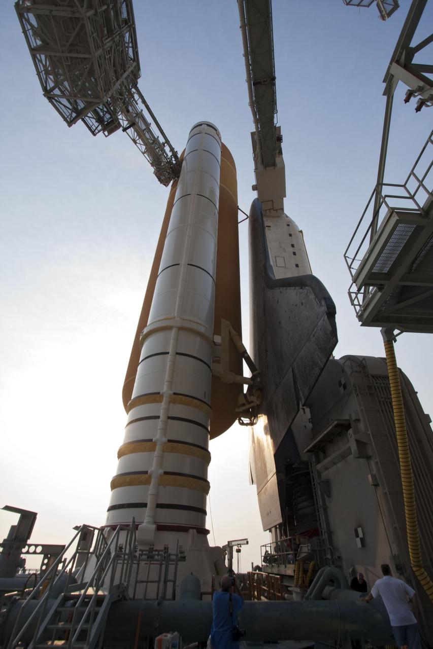 CAPE CANAVERAL, Fla. -- On Launch Pad 39A at NASA's Kennedy Space Center in Florida, the access arm supporting the pad's White Room is in place against space shuttle Atlantis. The room provides workers and astronauts an entry point to the shuttle's crew compartment. The Raffaello multi-purpose logistics module (MPLM) payload for space shuttle Atlantis' STS-135 mission to the International Space Station has been delivered to the pad. The payload canister will be lifted to the payload changeout room and the payload ground-handling mechanism then will be used to transfer Raffaello out of the canister into Atlantis' payload bay. Next, the rotating service structure that protects the shuttle from the elements and provides access will be rotated back into place.          Commander Chris Ferguson, Pilot Doug Hurley and Mission Specialists Sandy Magnus and Rex Walheim are targeted to lift off on space shuttle Atlantis July 8, taking with them the MPLM packed with supplies, logistics and spare parts to the International Space Station. The STS-135 mission also will fly a system to investigate the potential for robotically refueling existing satellites and return a failed ammonia pump module to help NASA better understand the failure mechanism and improve pump designs for future systems. STS-135 will be the 33rd flight of Atlantis, the 37th shuttle mission to the space station, and the 135th and final mission of NASA's Space Shuttle Program. For more information visit, www.nasa.gov/mission_pages/shuttle/shuttlemissions/sts135/index.html. Photo credit: NASA/Ken Thornsley